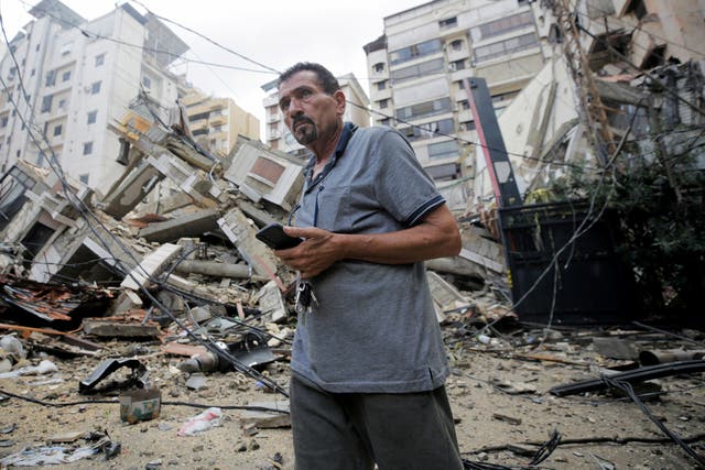 <p>A man stands near damaged buildings, in the aftermath of Israeli strikes on Beirut’s southern suburbs, Lebanon</p>