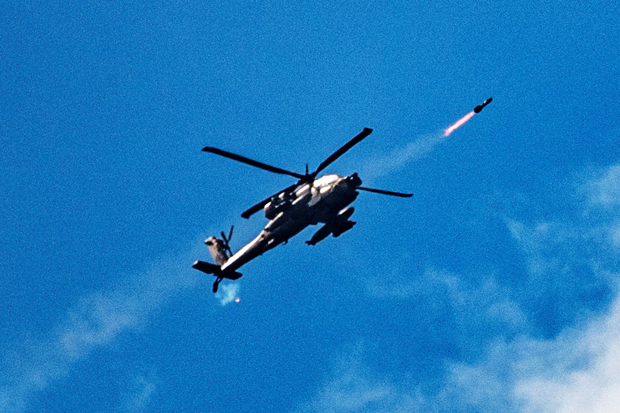 An Israeli attack helicopter fires towards Lebanon, amid cross-border hostilities between Hezbollah and Israel, as seen from northern Israel, October 1, 2024