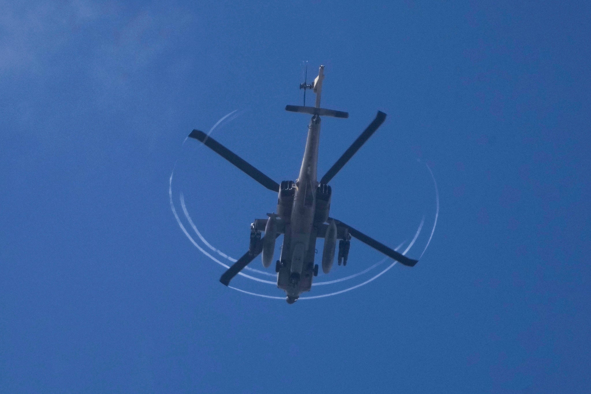 An armed Israeli Apache helicopter is seen from northern Israel, near the Israeli-Lebanon border