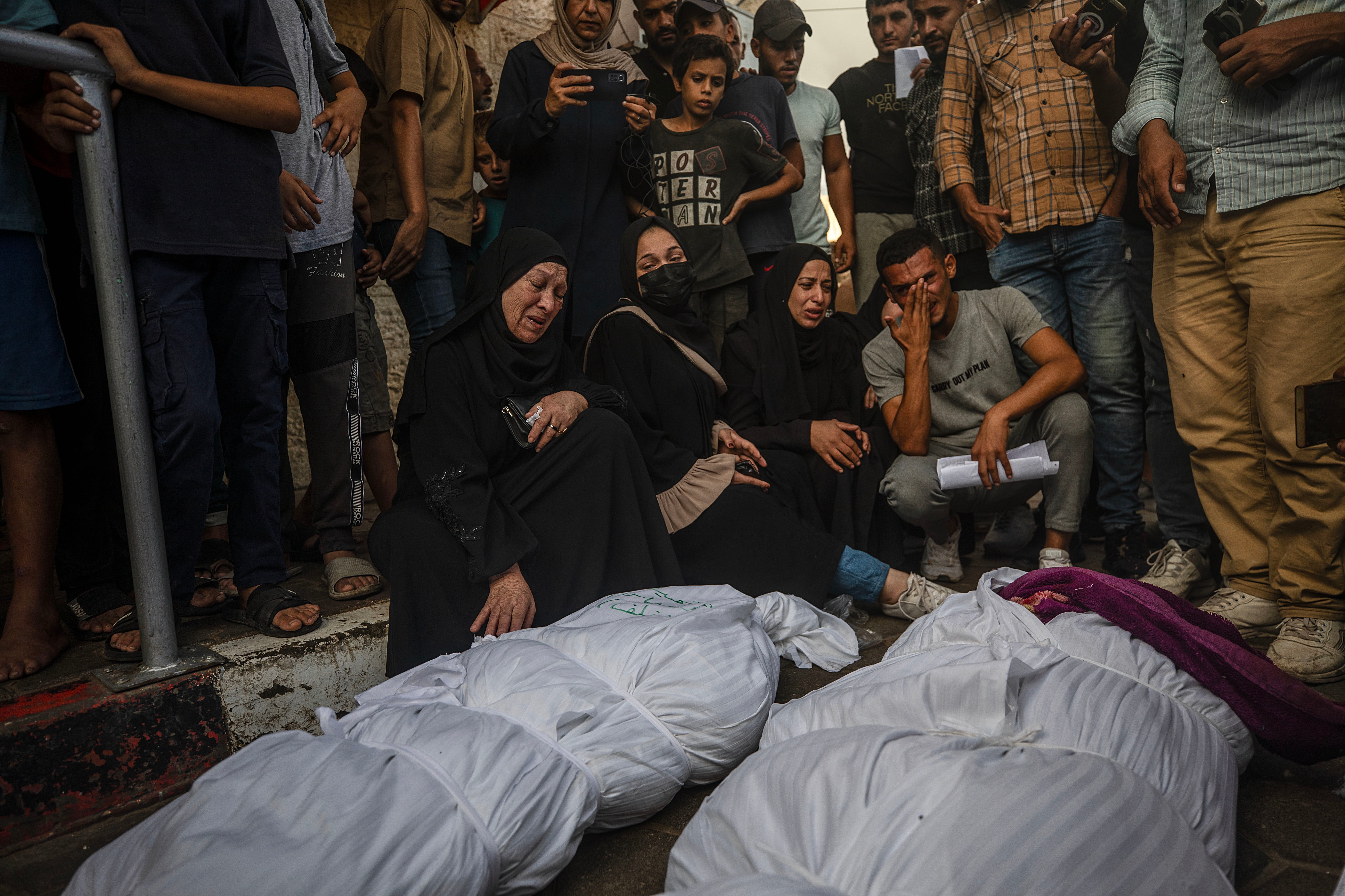 Relatives mourn their loved ones after an Israeli airstrike in Al Nusairat refugee camp in central Gaza Strip