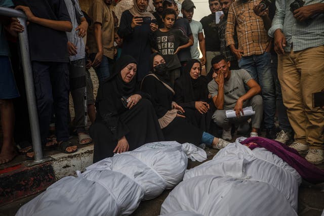 <p>Relatives mourn their loved ones after an Israeli airstrike in Al Nusairat refugee camp in central Gaza Strip</p>