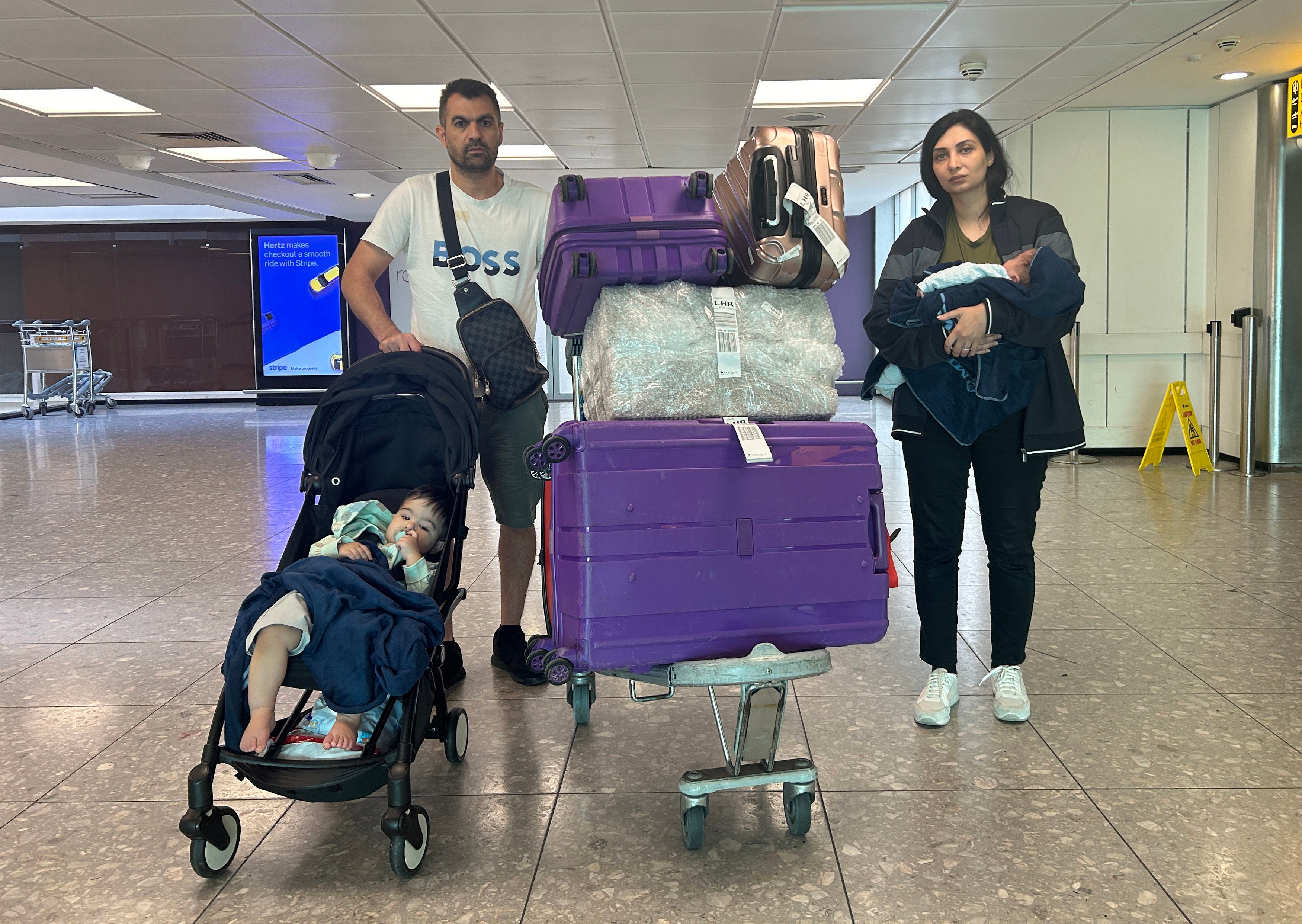 Abbas Chamseddin with his wife Sana and their two sons Zien and Jawad (in buggy) at Heathrow Airport after they flew in from Beirut