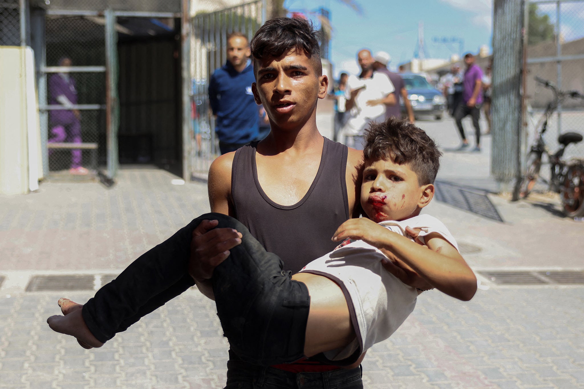 Palestinians transport casualties of an Israeli bombardment to a displacement camp in Khan Younis