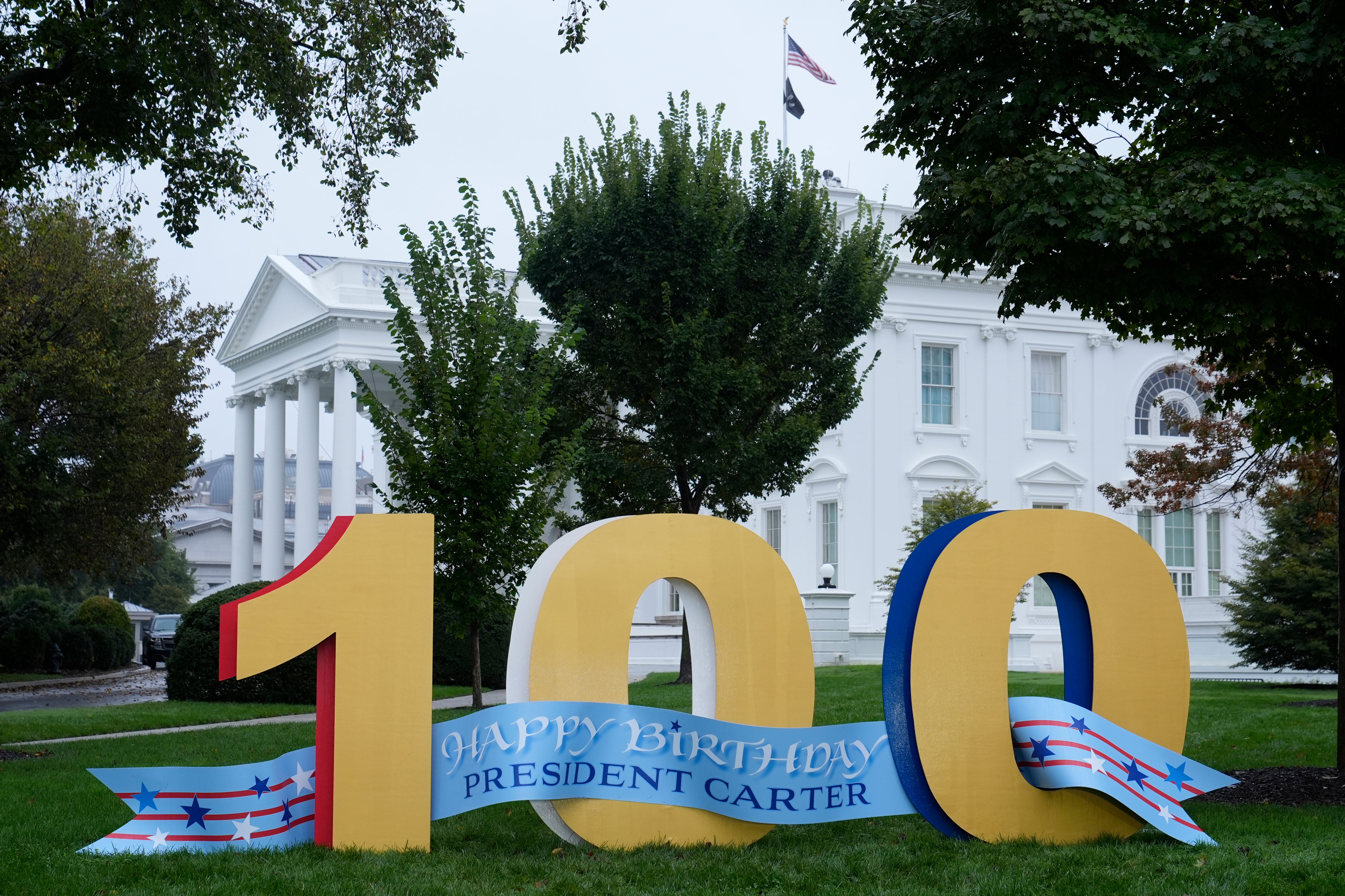 A sign wishing former President Jimmy Carter a happy 100th birthday sits on the North Lawn of the White House in Washington, DC, on October 1