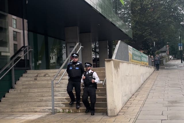 <p>Police on footpatrol walk by the main entrance of Westminster Academy </p>