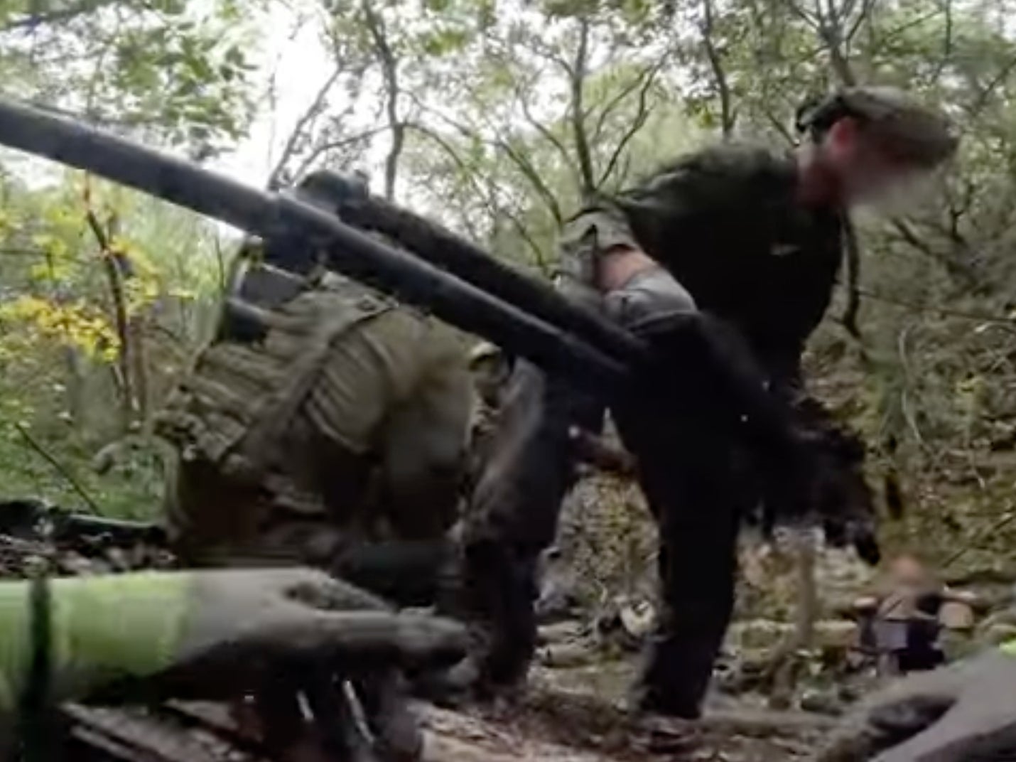 An image taken from footage provided by the Israeli military shows a soldier removing Hezbollah weapons from a tunnel near the border with Israel