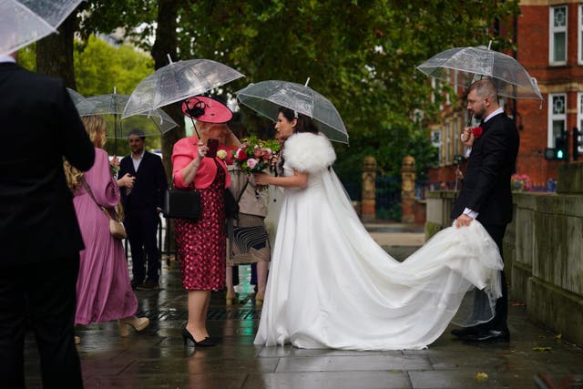 A couple arrive for their wedding at Old Marylebone Town Hall (Yui Mok/PA)