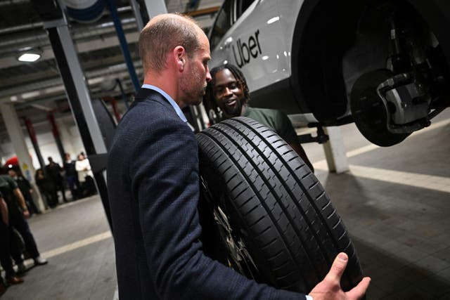 The Prince of Wales holds a car tyre during a visit to the 2023 Earthshot Prize Finalist, ENSO, in Brentford, west London (Chris J Ratcliffe/PA)