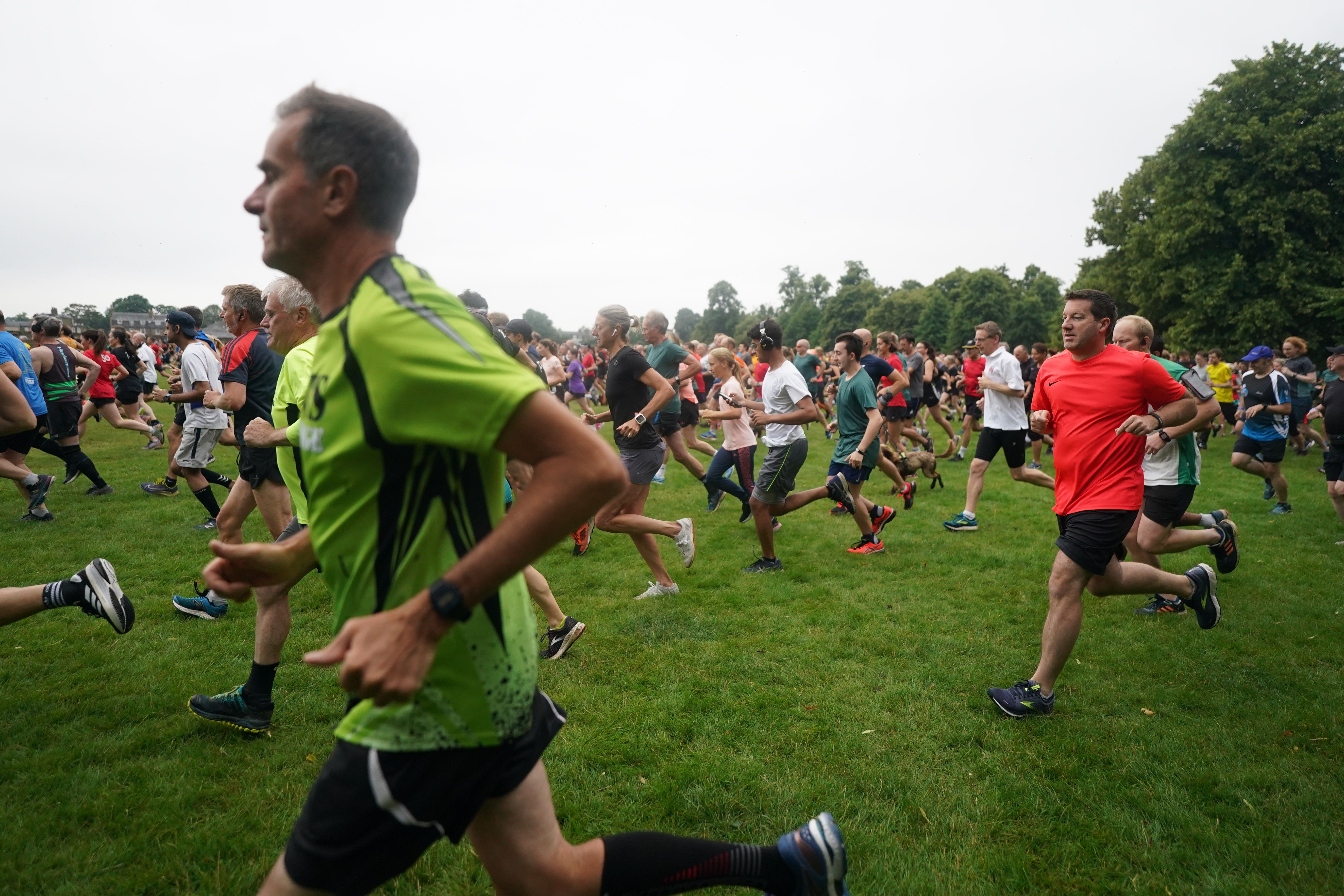 People take part in the Park Run at Bushy Park in London (Victoria Jones/PA)