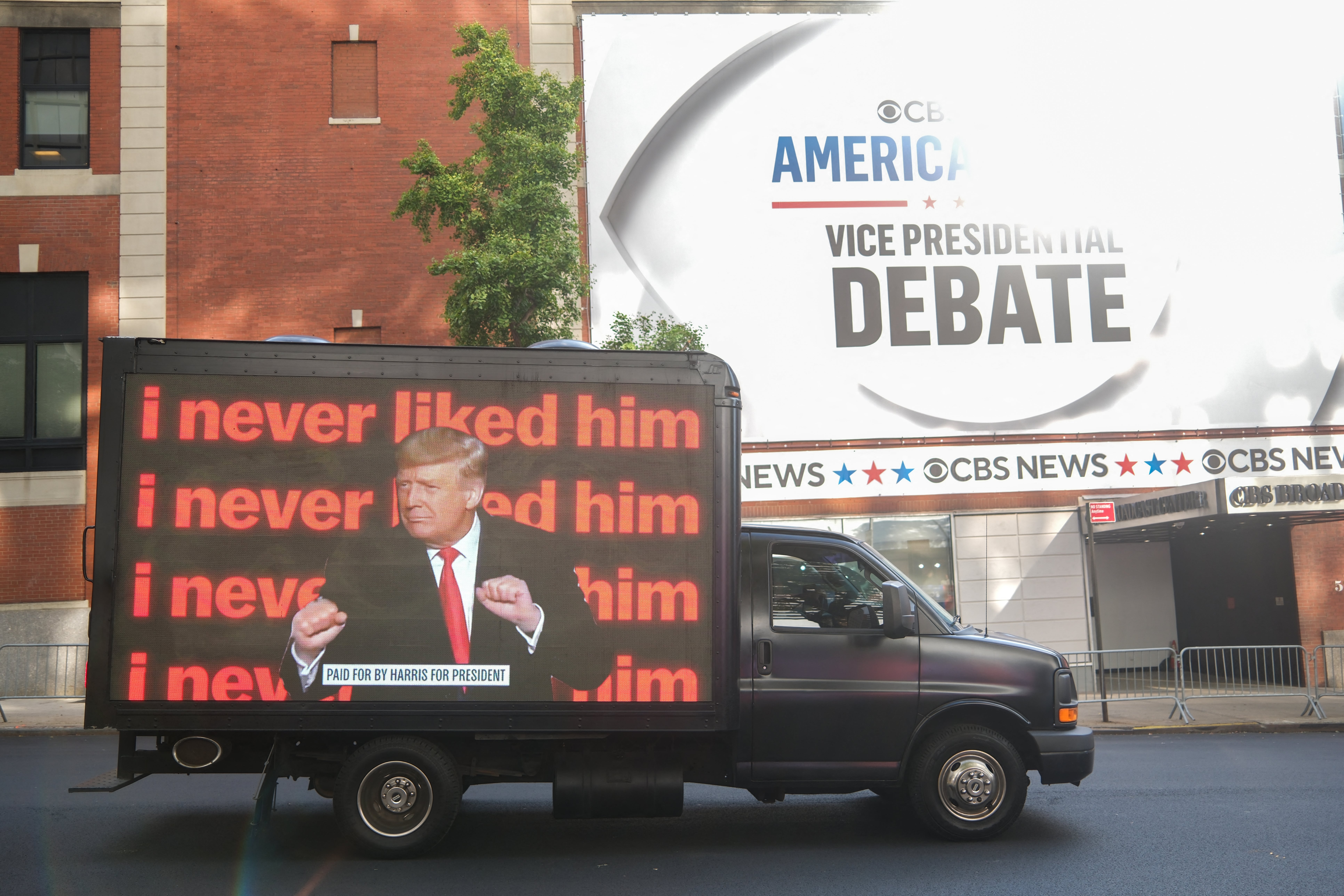 A van with an anti-Trump message drives near the CBS Broadcast Center in New York City ahead of the vice presidential debate between JD Vance and Tim Walz on October 1