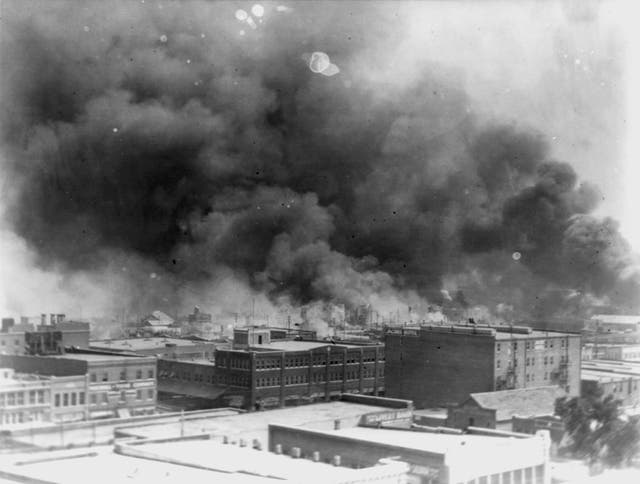 <p>In this 1921 image provided by the Library of Congress, smoke billows over Tulsa, Oklahoma during a racist massacre</p>