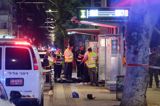 <p>Israeli forensic officers inspect the site of a shooting incident in Tel Aviv, Israel, on Tuesday </p>