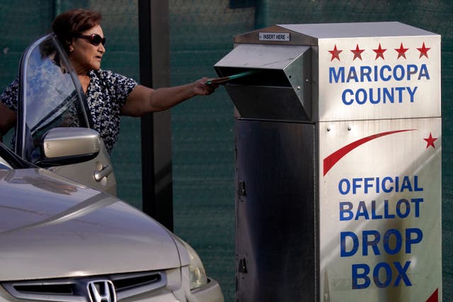 <p>A voter casts a ballot at a secure drop box at the Maricopa County Tabulation and Election Center in 2022. The number of Arizonans impacted by glitch threatening voting rights climbs to more than 200,000 people </p>