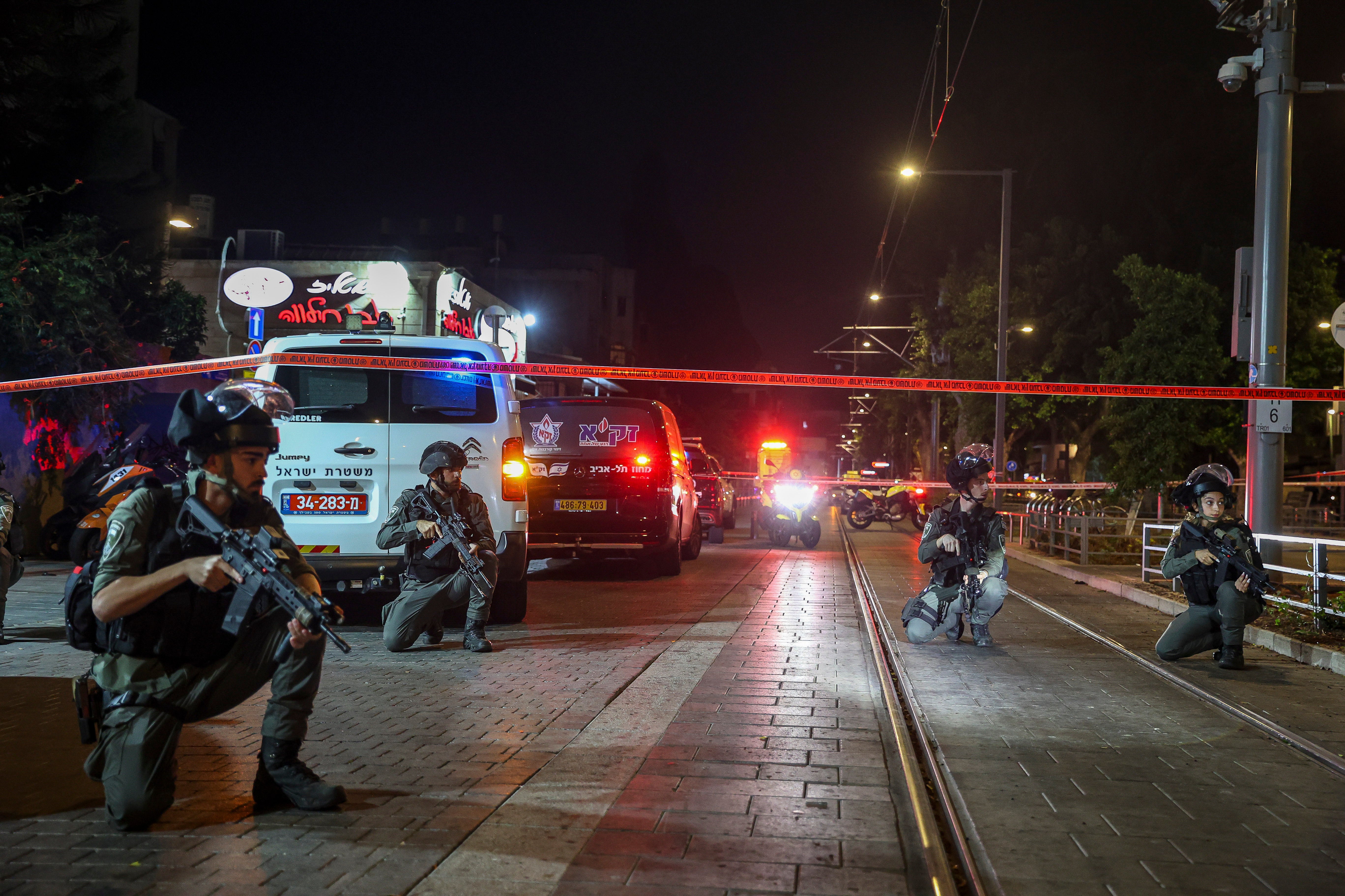 Israeli policemen take position after the shooting attack in Jaffa