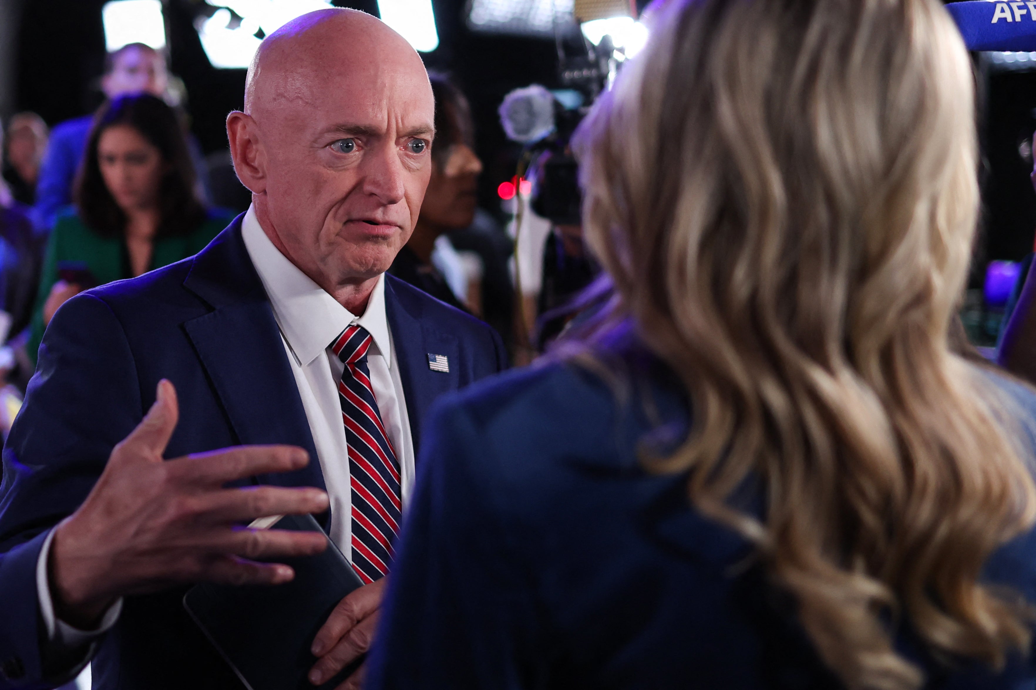 US Senator Mark Kelly, Democrat of Arizona, speaks to reporters in the spin room ahead of the Vice Presidential debate