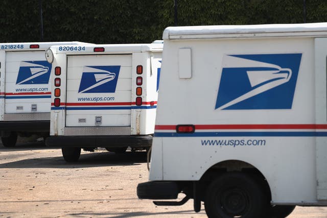 <p>Chicago police and US Marshals arrested murder suspect in Cedar Rapids, Iowa, on September 30. Postal Service vans in Chicago are pictured </p>