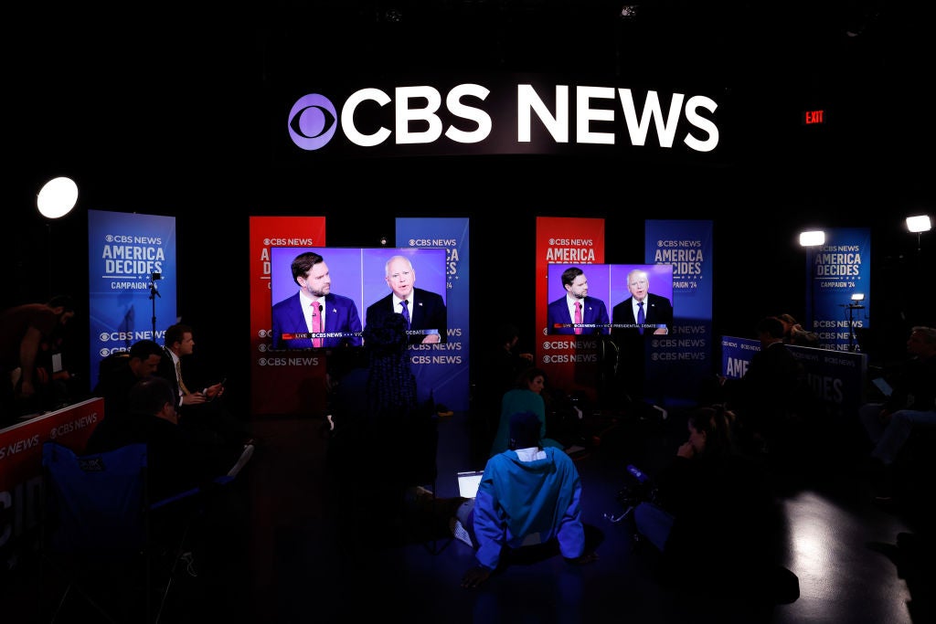 Journalists watch the VP debate between Tim Walz and JD Vance from the spin room at the CBS broadcast center in New York