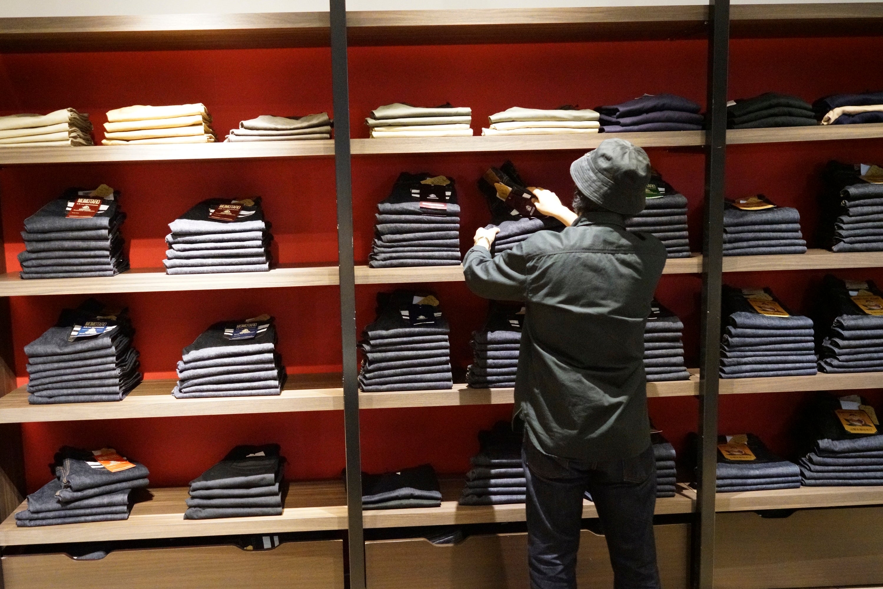 Fashion Shop clerk Yuta Akagi displays the jeans at Momotaro Jeans shop in Tokyo