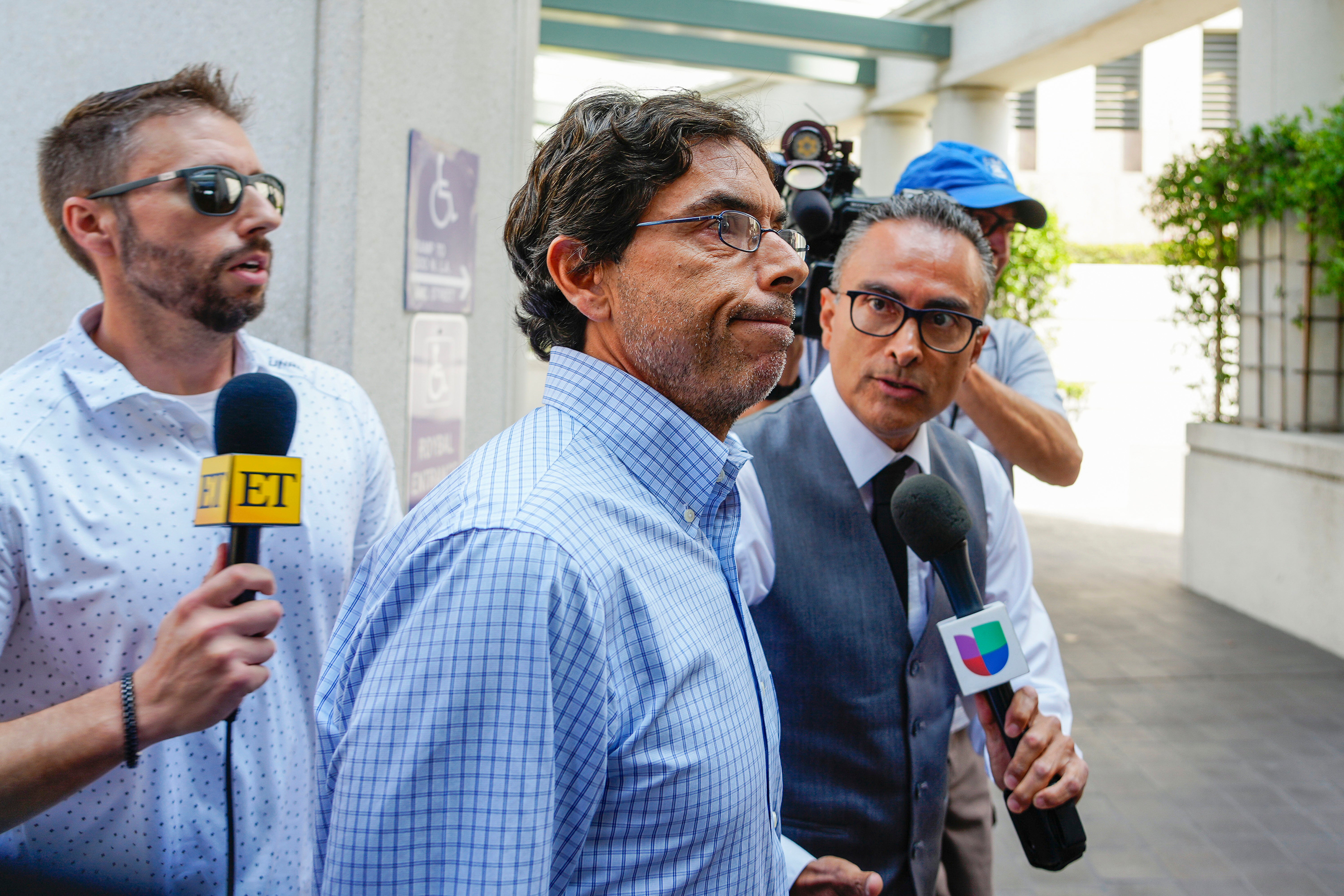 Dr. Mark Chavez, center, a San Diego doctor charged in connection with the death of actor Matthew Perry