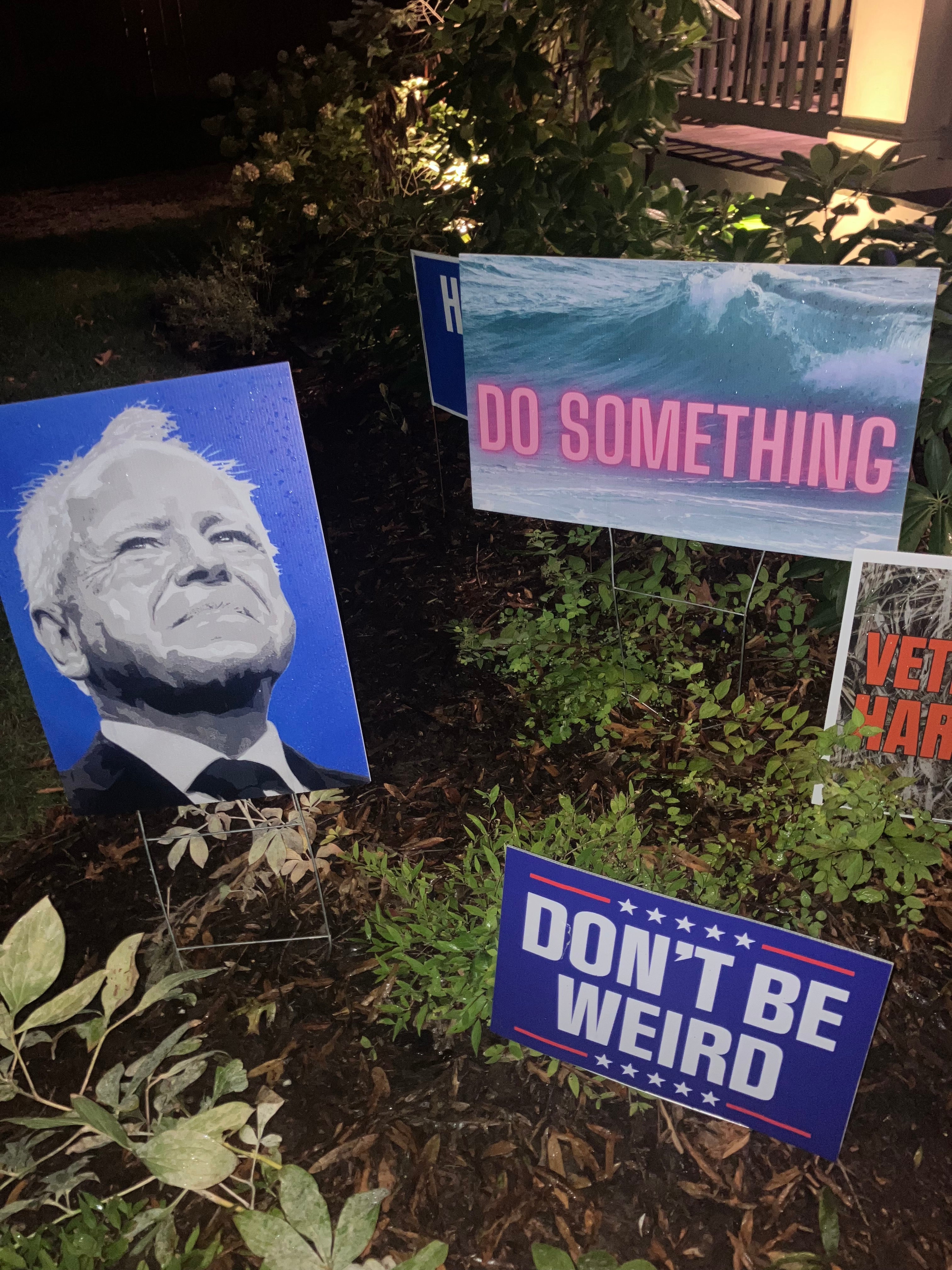 Posters of Governor Tim Walz and ‘Don’t be weird’ slogans were on the lawn outside the debate watch party