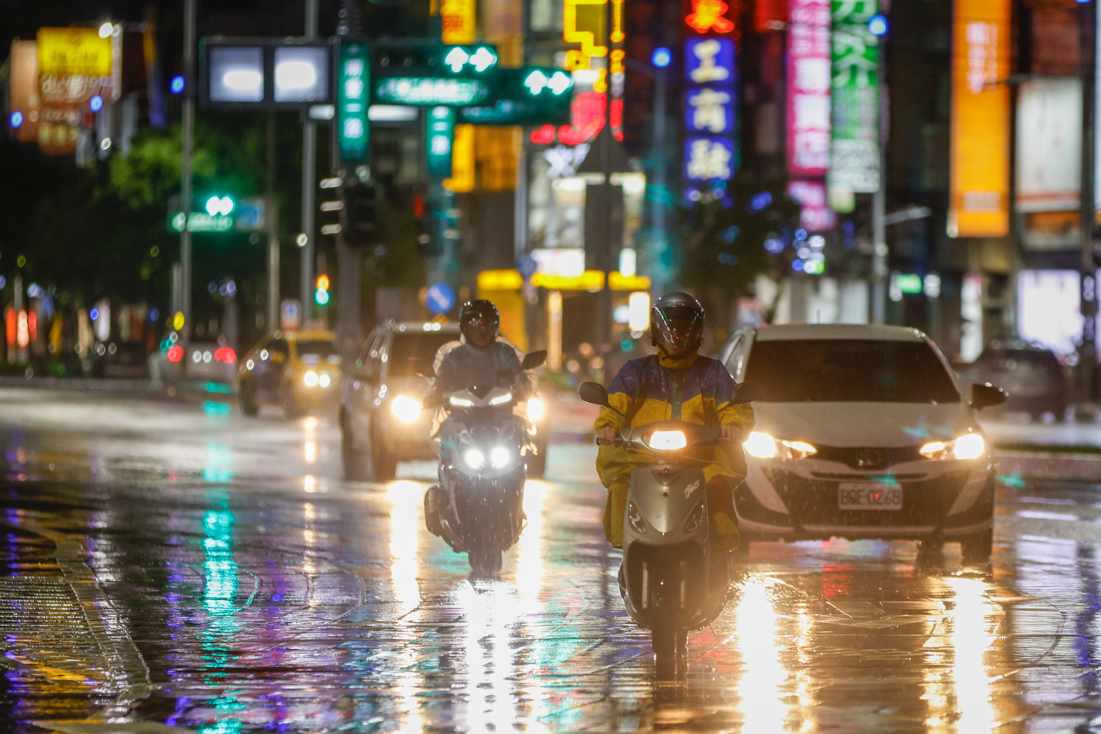 Motorists drive through the rain brought by Typhoon Krathon in Kaohsiung city, Taiwan