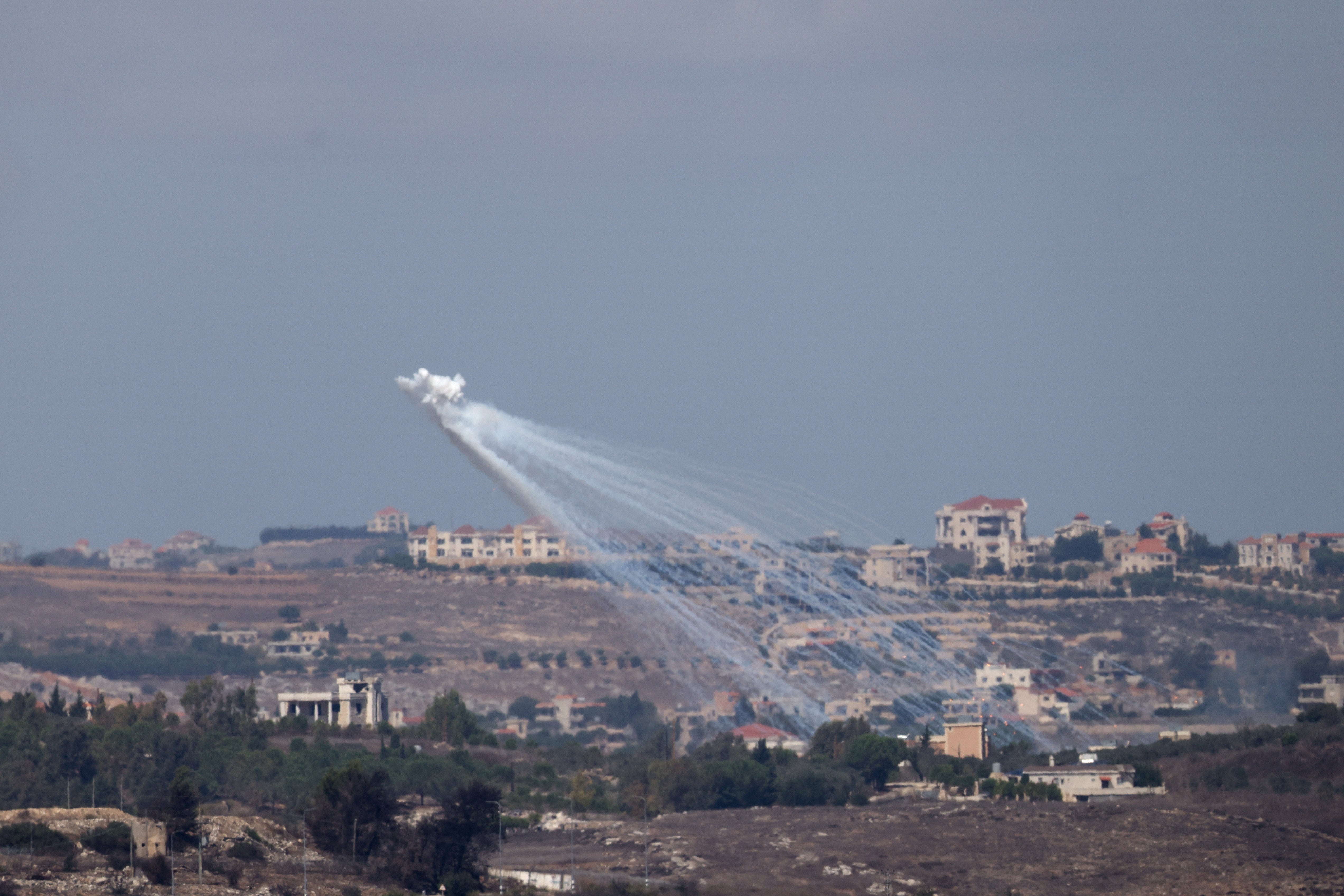 Artillery is fired by the Israeli army into Lebanon, amid cross-border hostilities between Hezbollah and Israel, as seen from Jish, northern Israel