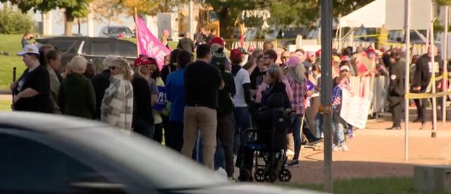 <p>Dozens of supporters of Former President Donald Trump waiting outside Discovery World in Milwaukee on Tuesday</p>