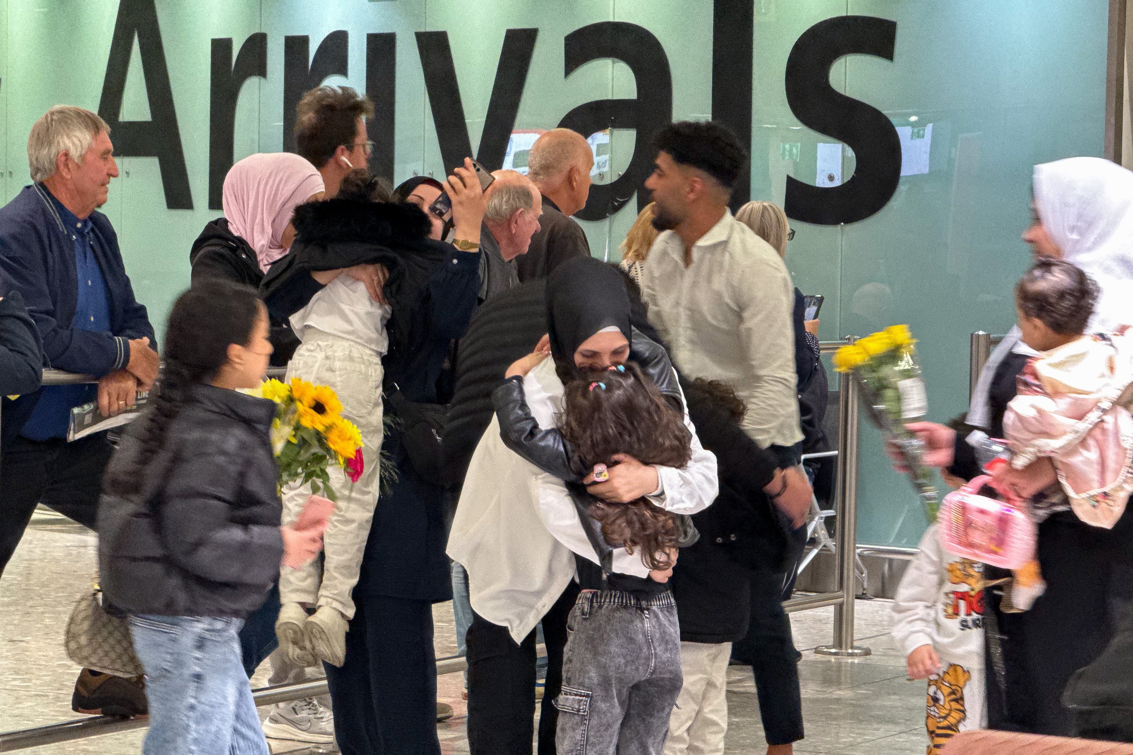 People greet their family members arriving via a commercial flight from Beirut on Wednesday