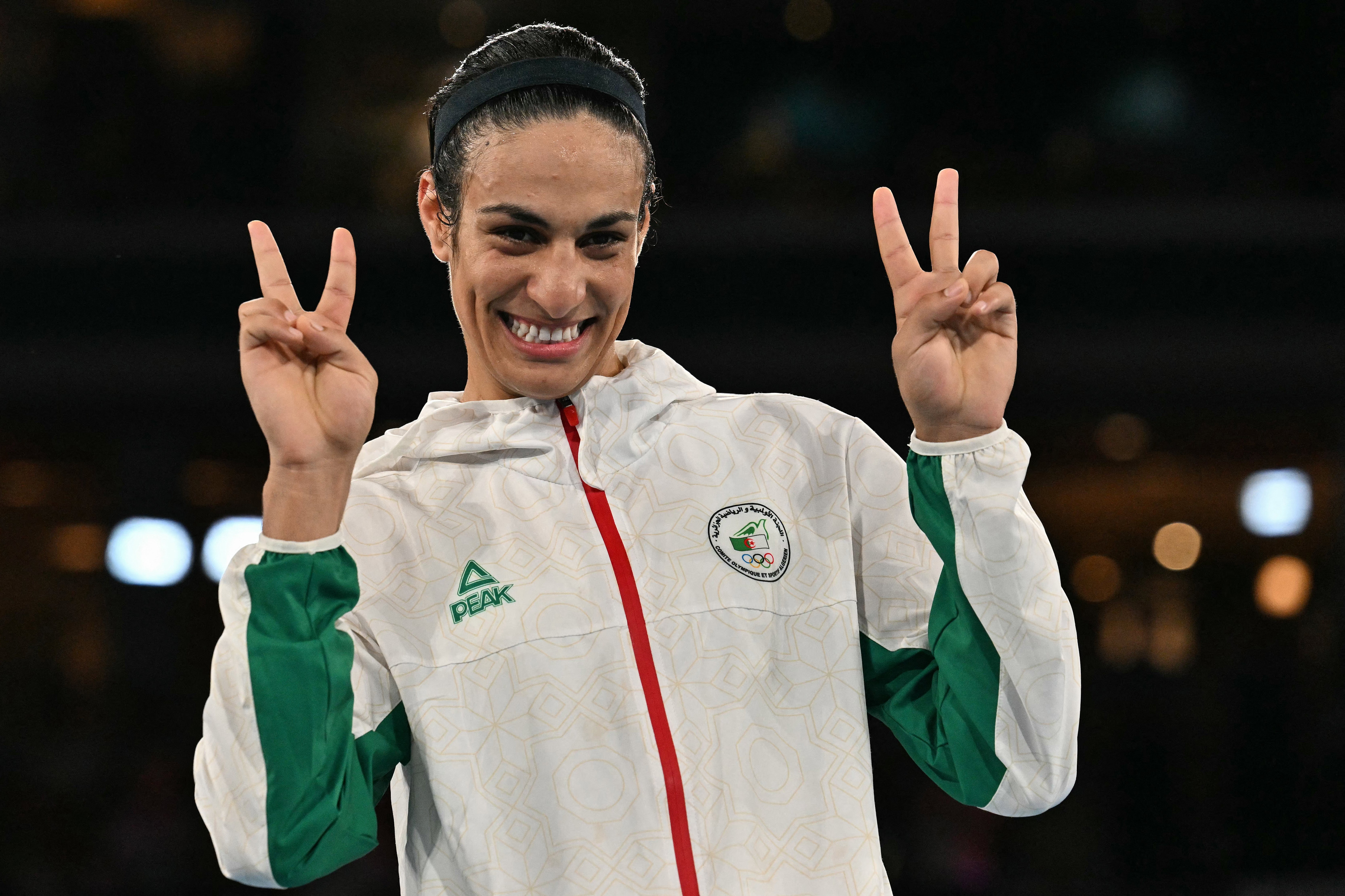 Algeria's Imane Khelif poses on the podium at the Olympics after winning gold