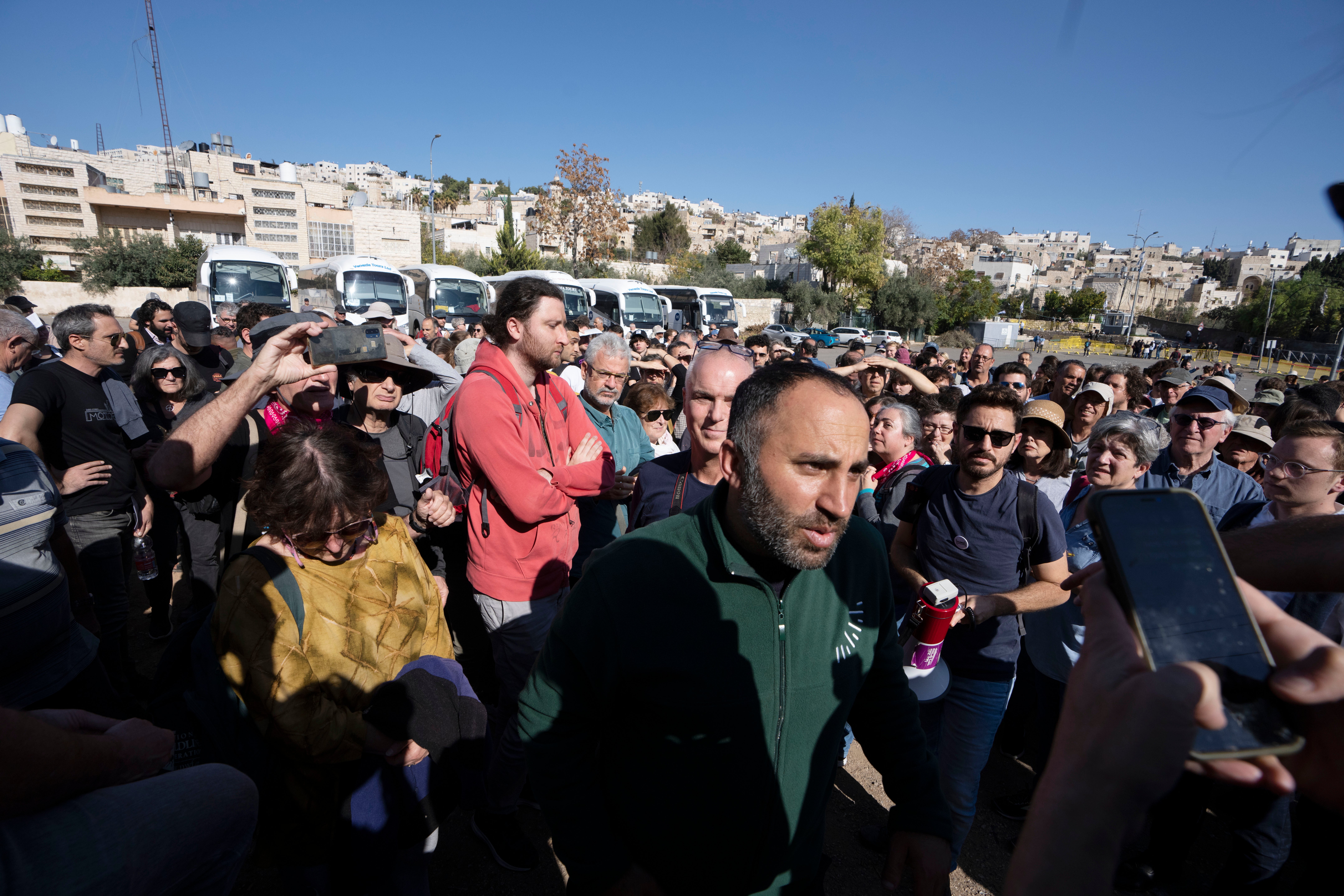 Palestinian activist Issa Amro, center, stands with Israeli activists in the embattled West Bank city of Hebron