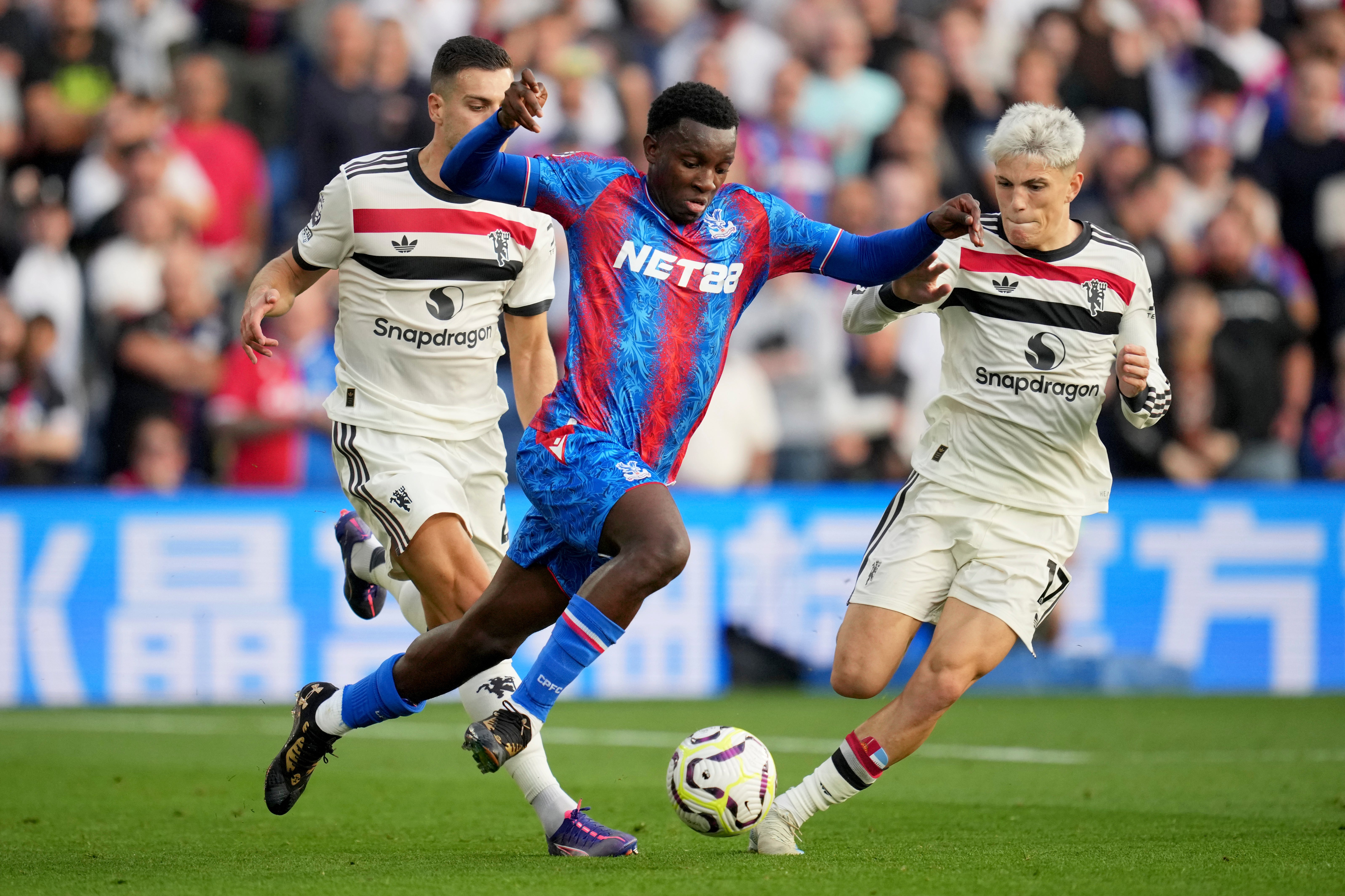 Nketiah takes on Manchester United defenders at Selhurst Park