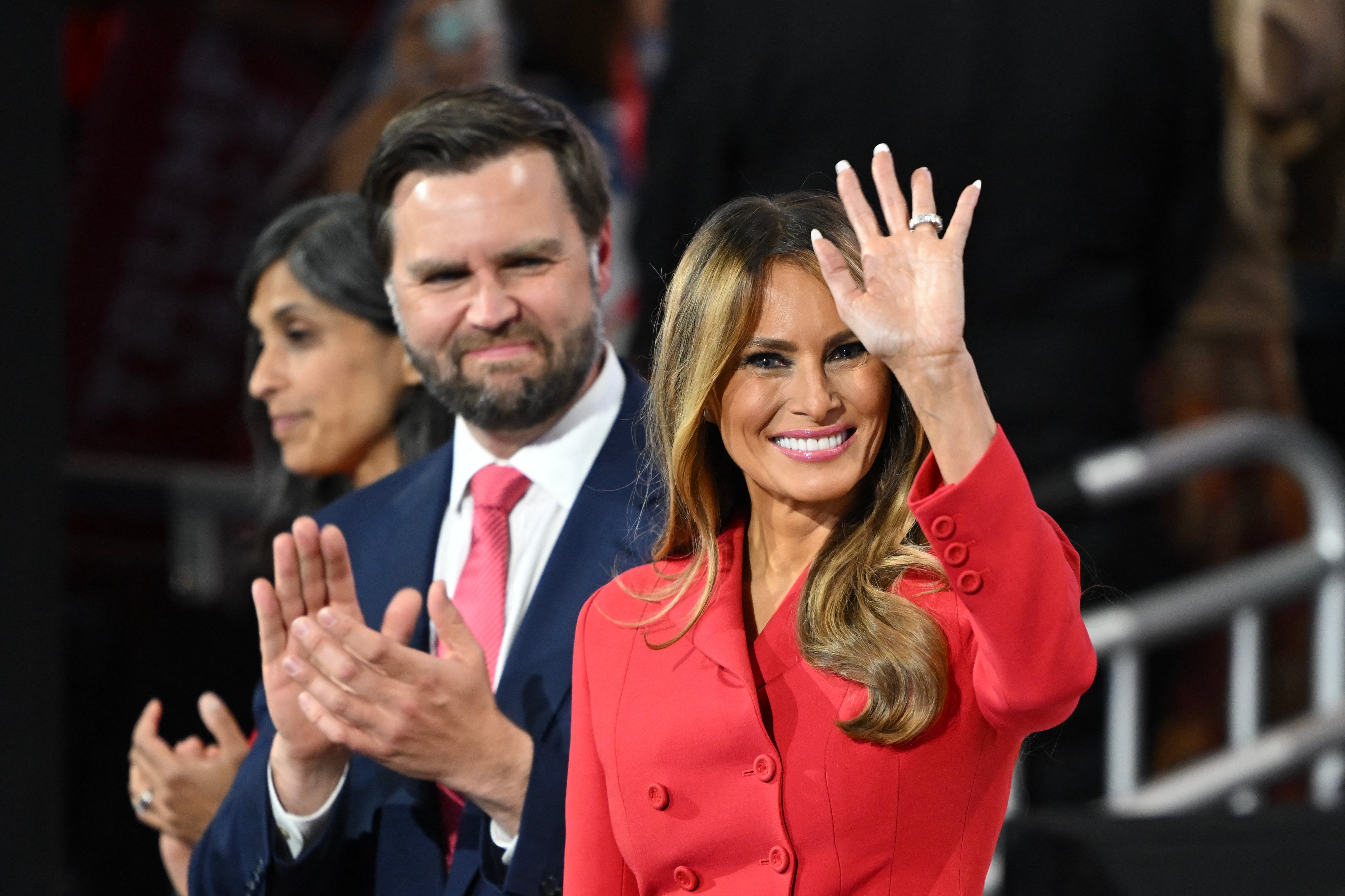 Melania Trump waves next to JD Vance at the Republican National Convention. Melania came out in support of abortion rights in her forthcoming memoir, sparking anger from anti-abortion advocates