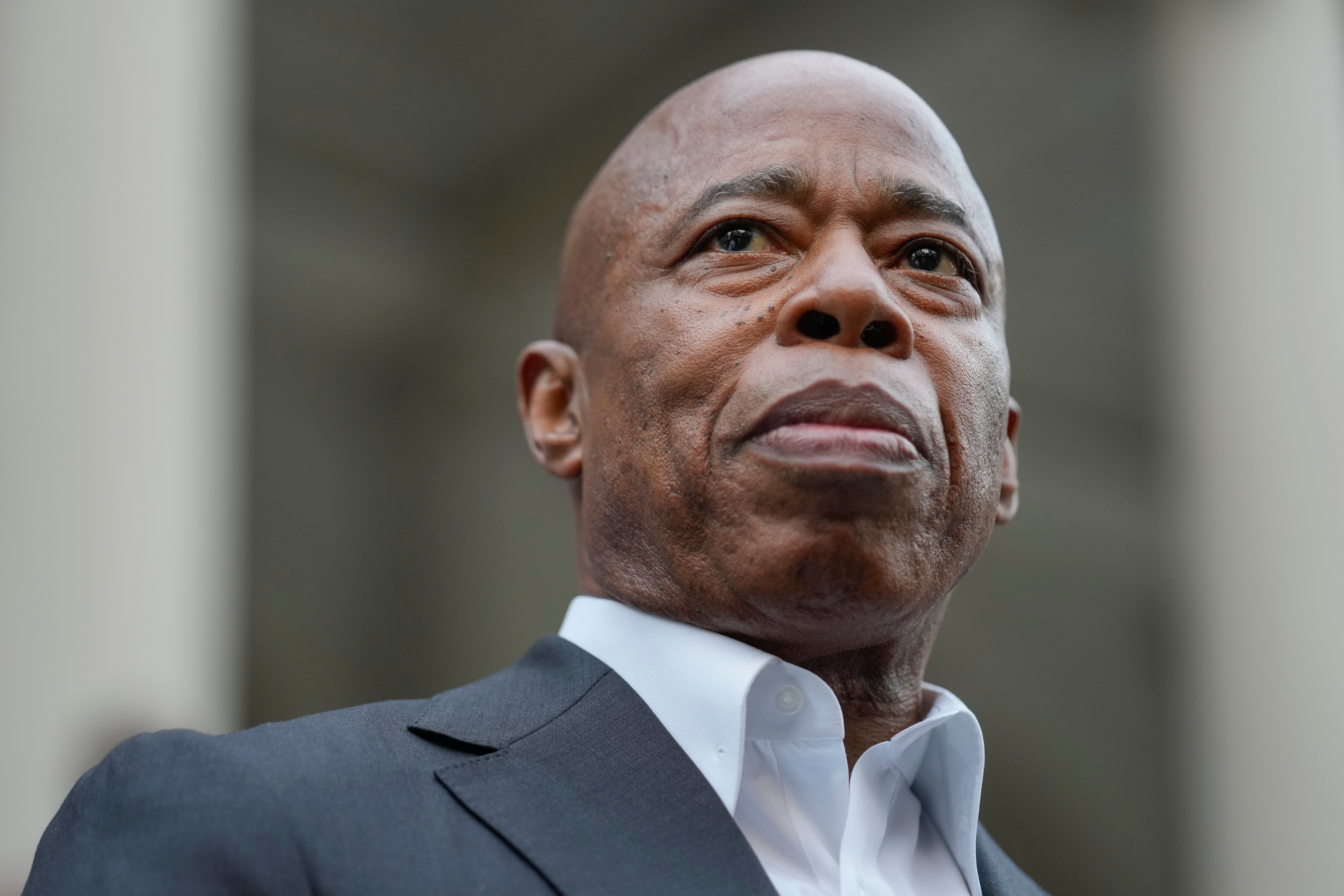 New York City Mayor Eric Adams looks on while surrounded by faith leaders and other supporters during a rally and prayer vigil on the steps of City Hall in New York, Tuesday, Oct. 1, 2024.