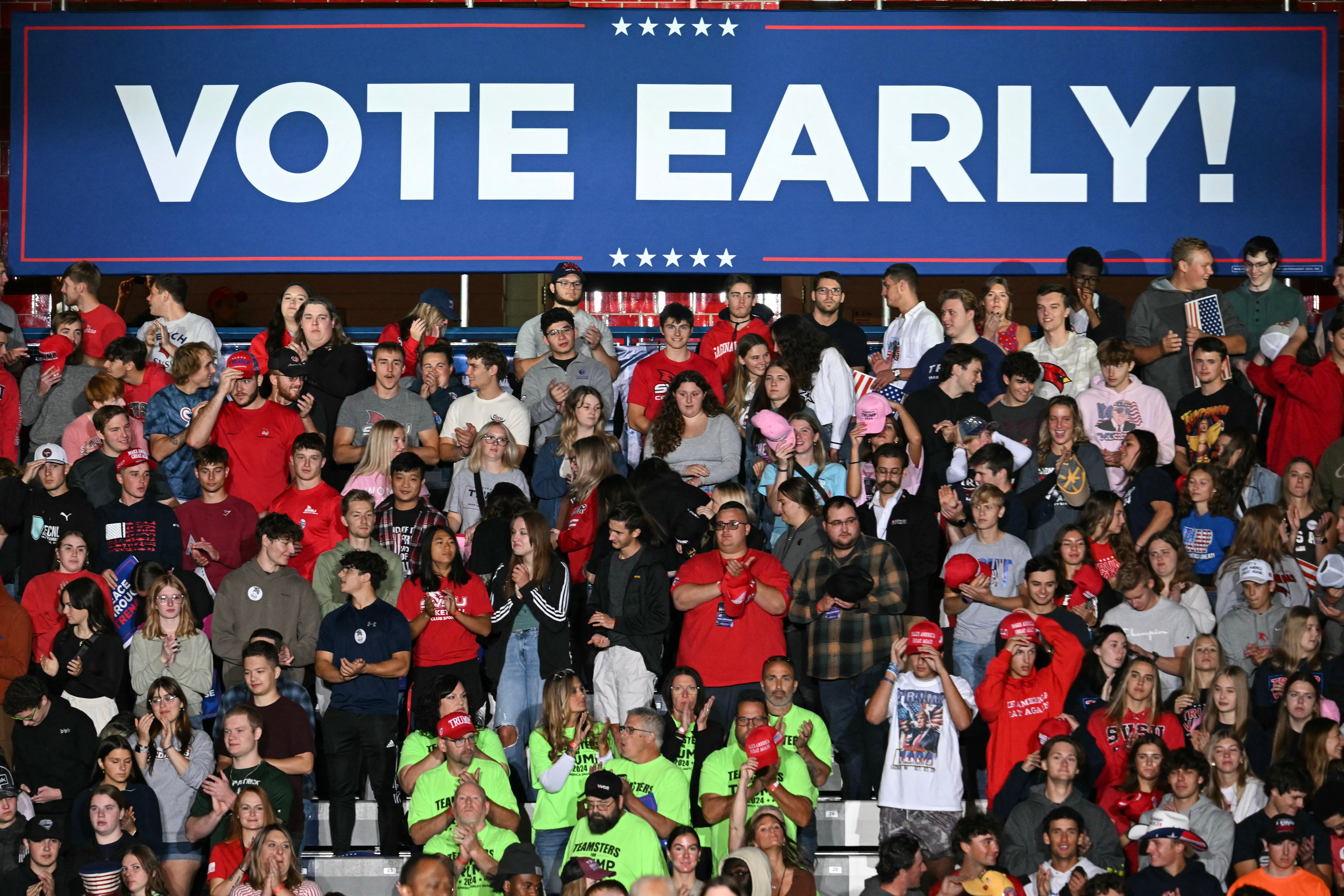 Supporters wait for the arrival of former US President and Republican presidential candidate Donald Trump during campaign rally at the Ryder Center for Health and Physical Education at Saginaw Valley State University in Michigan