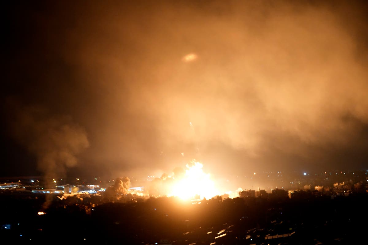 Israeli airstrikes rock southern suburbs of Beirut and cut off a key crossing into Syria