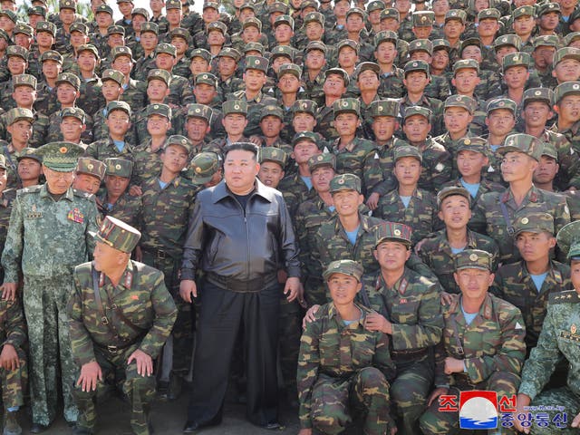 <p>North Korea's leader Kim Jong-un posing with troops during an inspection at a training base of the Korean People's Army's special operations forces in the western region on 2 Oct </p>