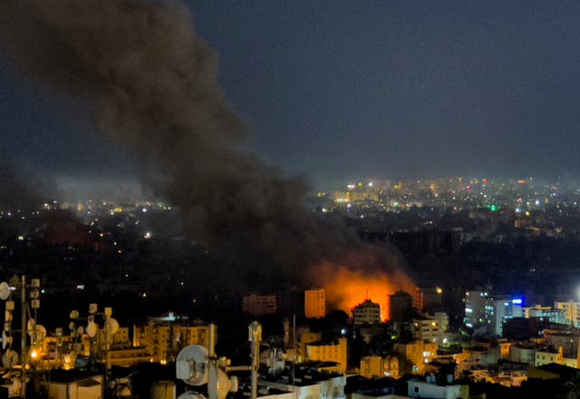 Flames and smoke rise from Israeli airstrikes in Dahiyeh, Beirut on Thursday night (Hussein Malla/AP)