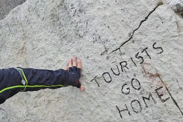 <p>The anti-tourism message was found on a rock in the Dolomites  </p>