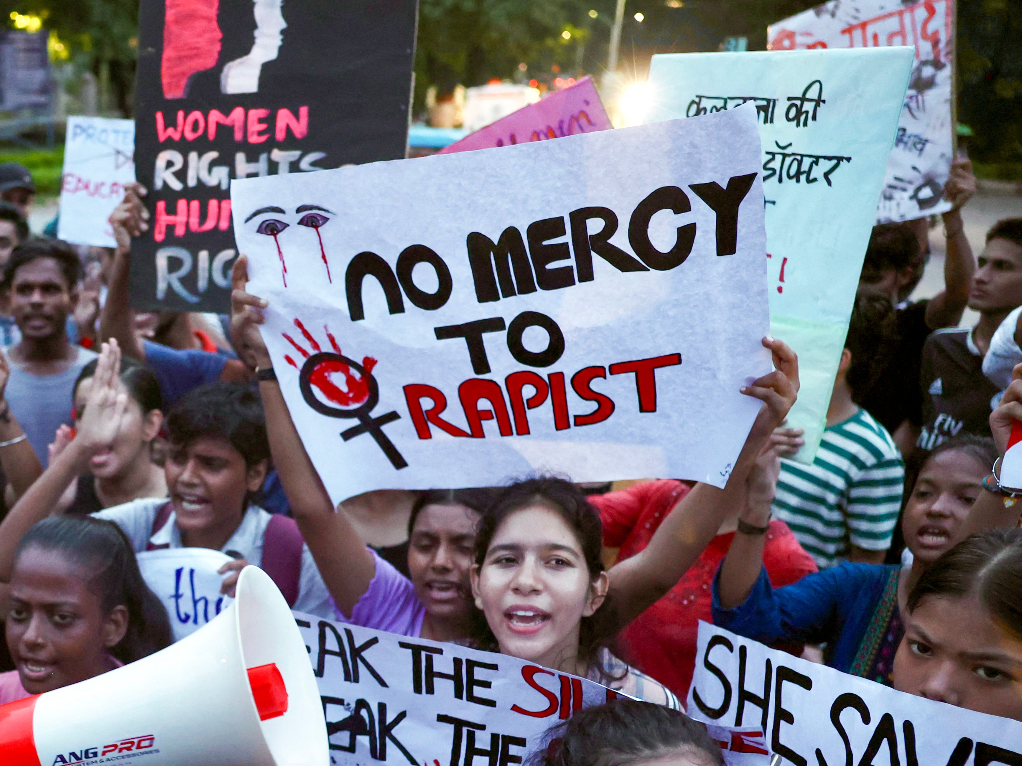 Students hold posters and shout slogans during a march in Varanasi on 20 August 2024, amid nationwide strike by medical practitioners to condemn rape