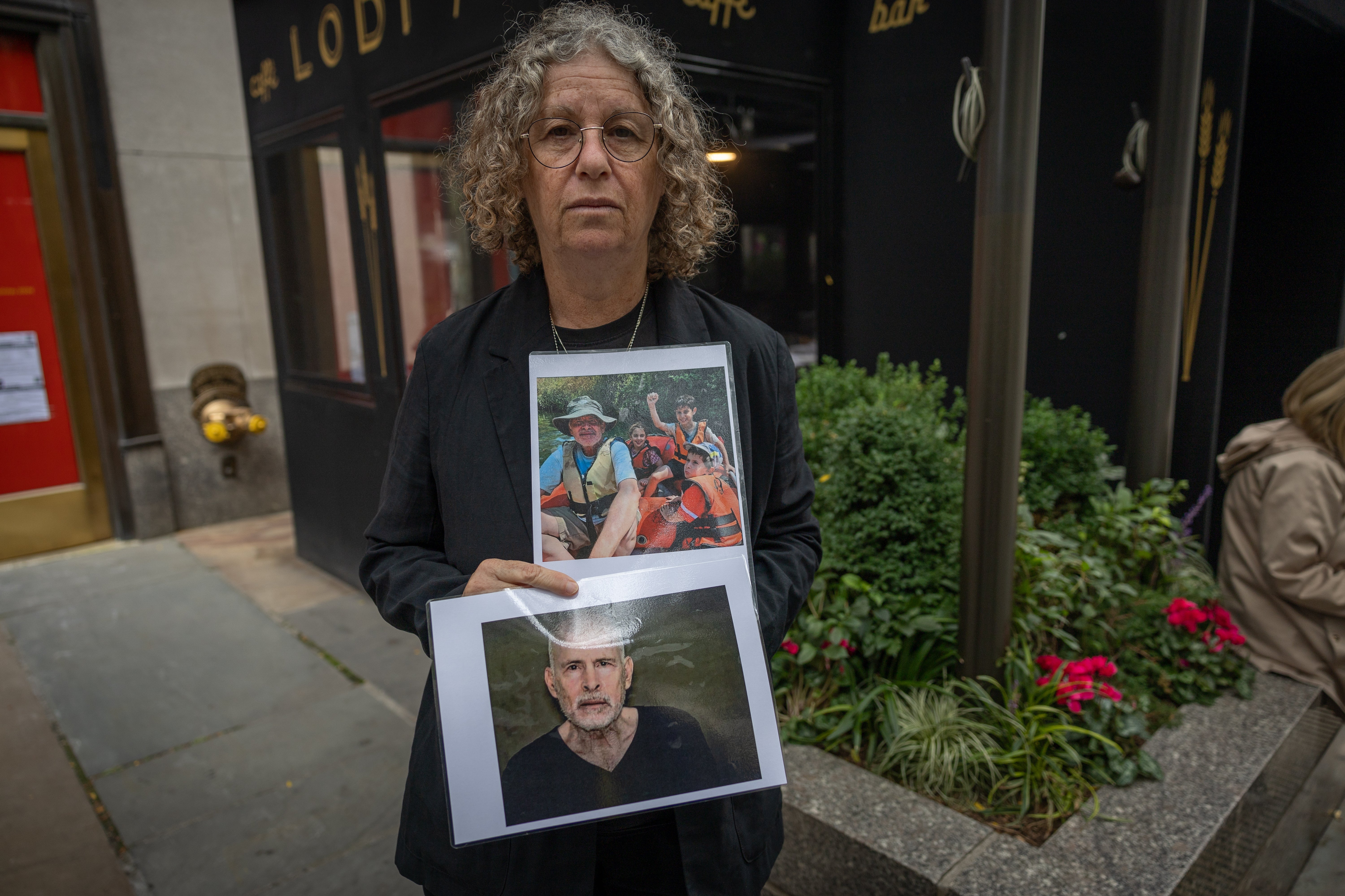 Aviva Siegel, a former hostage, holds an image of her husband Keith, a native of North Carolina who is being held captive