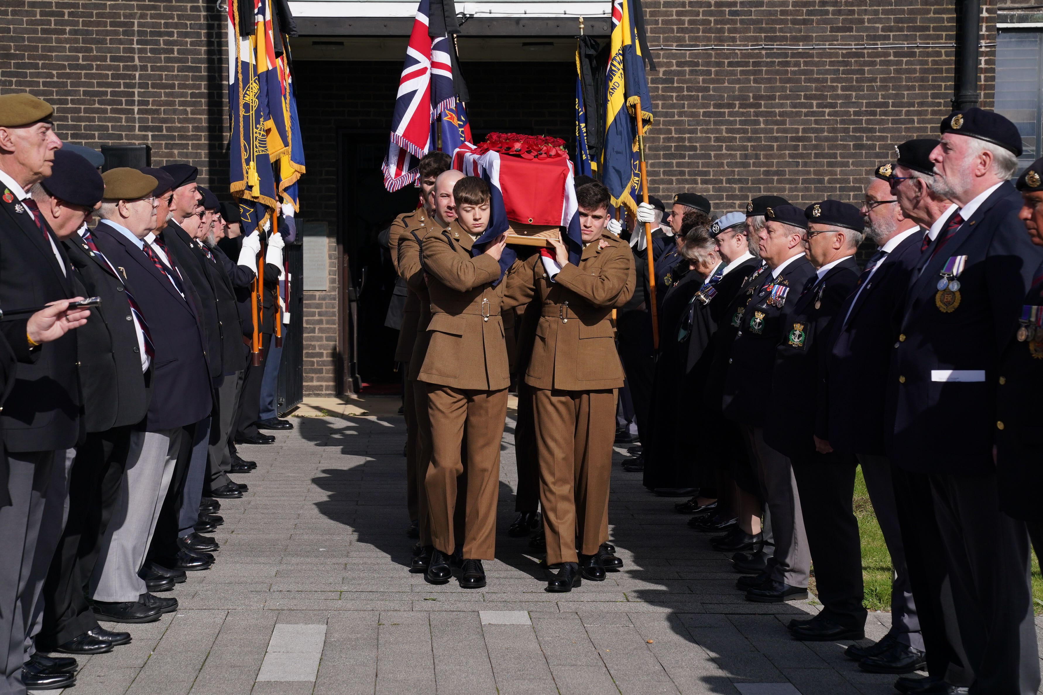 Military personnel and veterans form a guard of honour for the bearer party at the funeral of 104-year-old D-Day veteran Don Sheppard (Lucy North/PA)