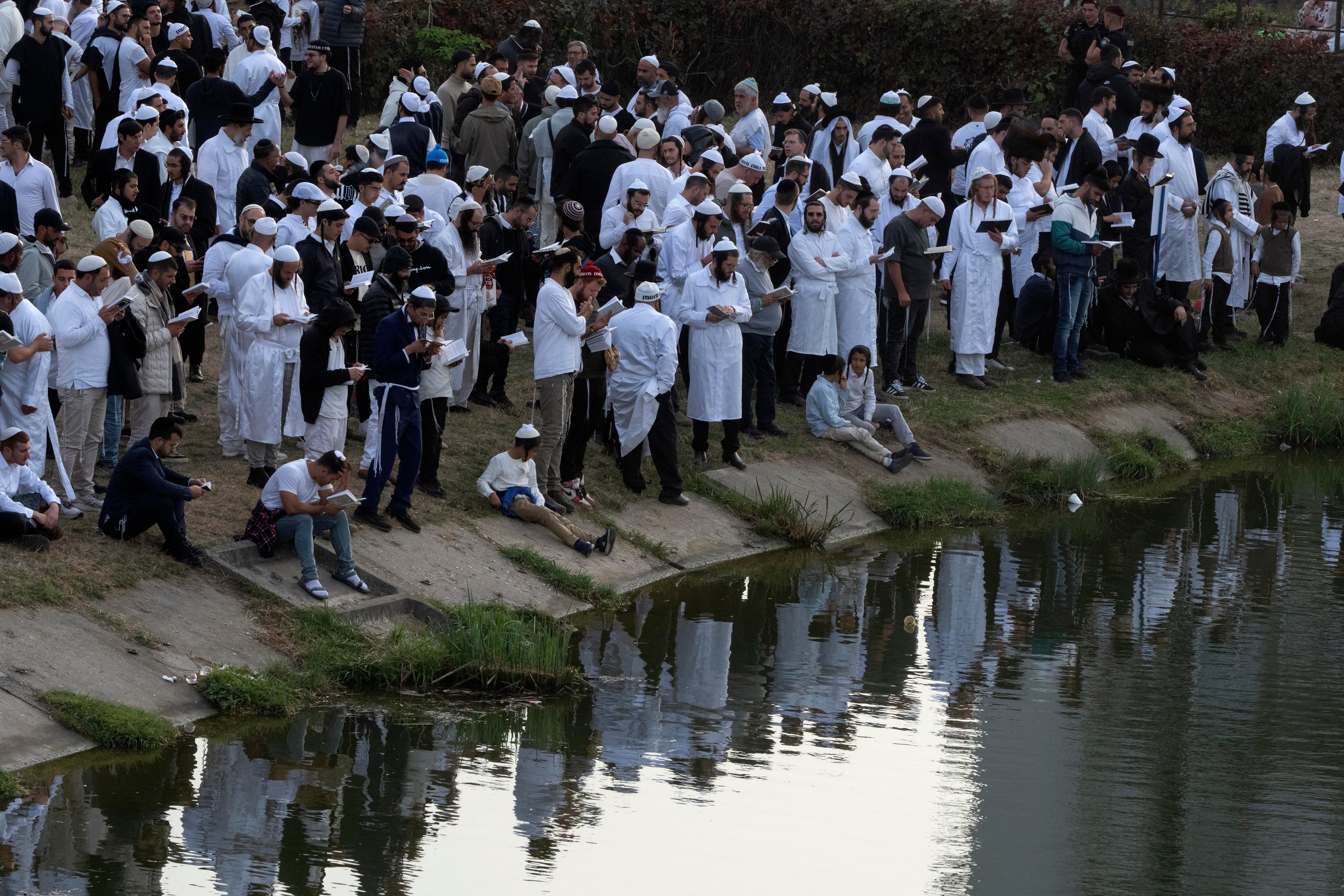 Orthodox Jews pray near the lake at the tomb of Rabbi Nachman