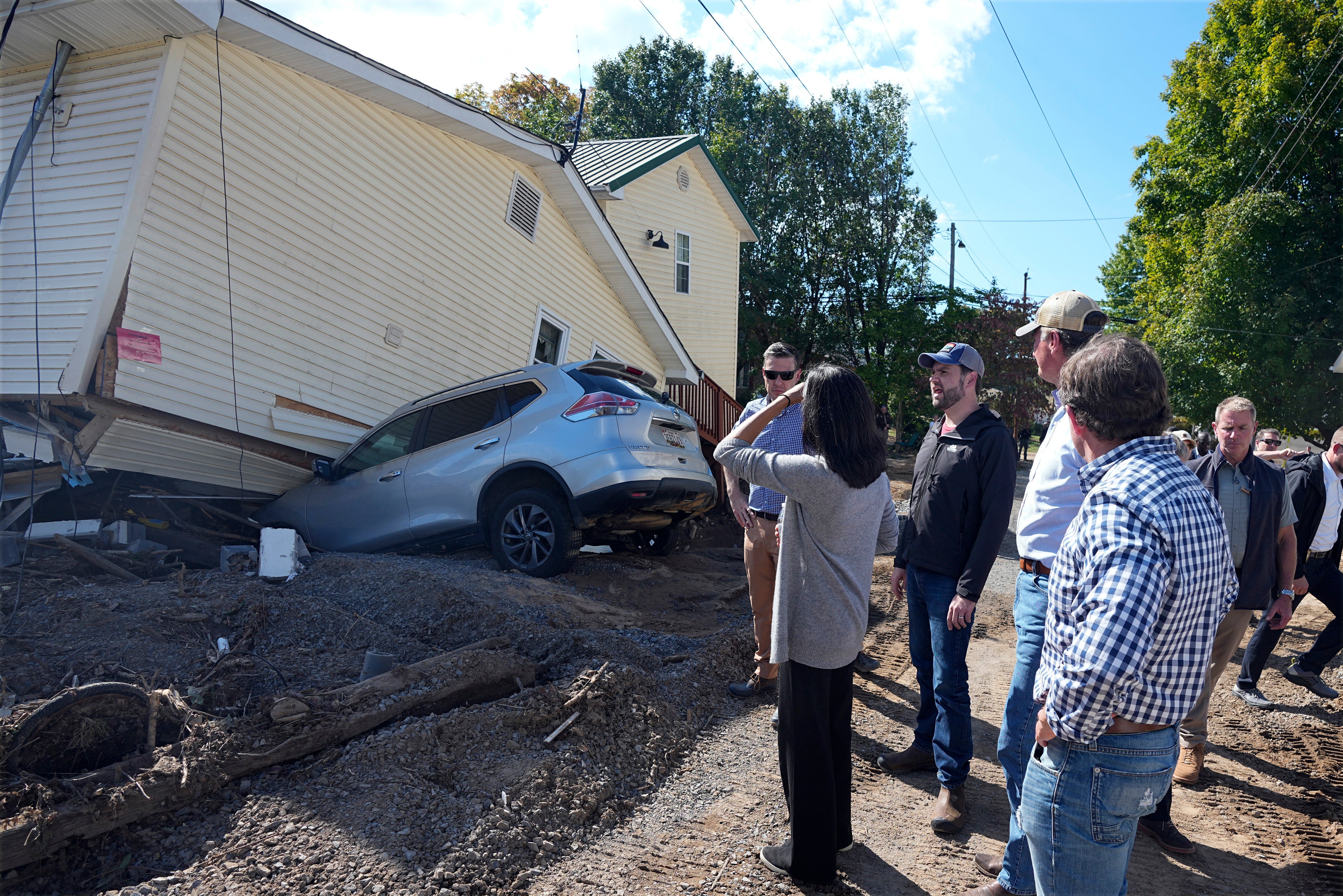 Republican vice presidential candidate Sen. JD Vance, R-Ohio, and his wife Usha Vance, center front, visit areas affected by Hurricane Helene in Damascus, Virginia, Thursday, October 3, 2024