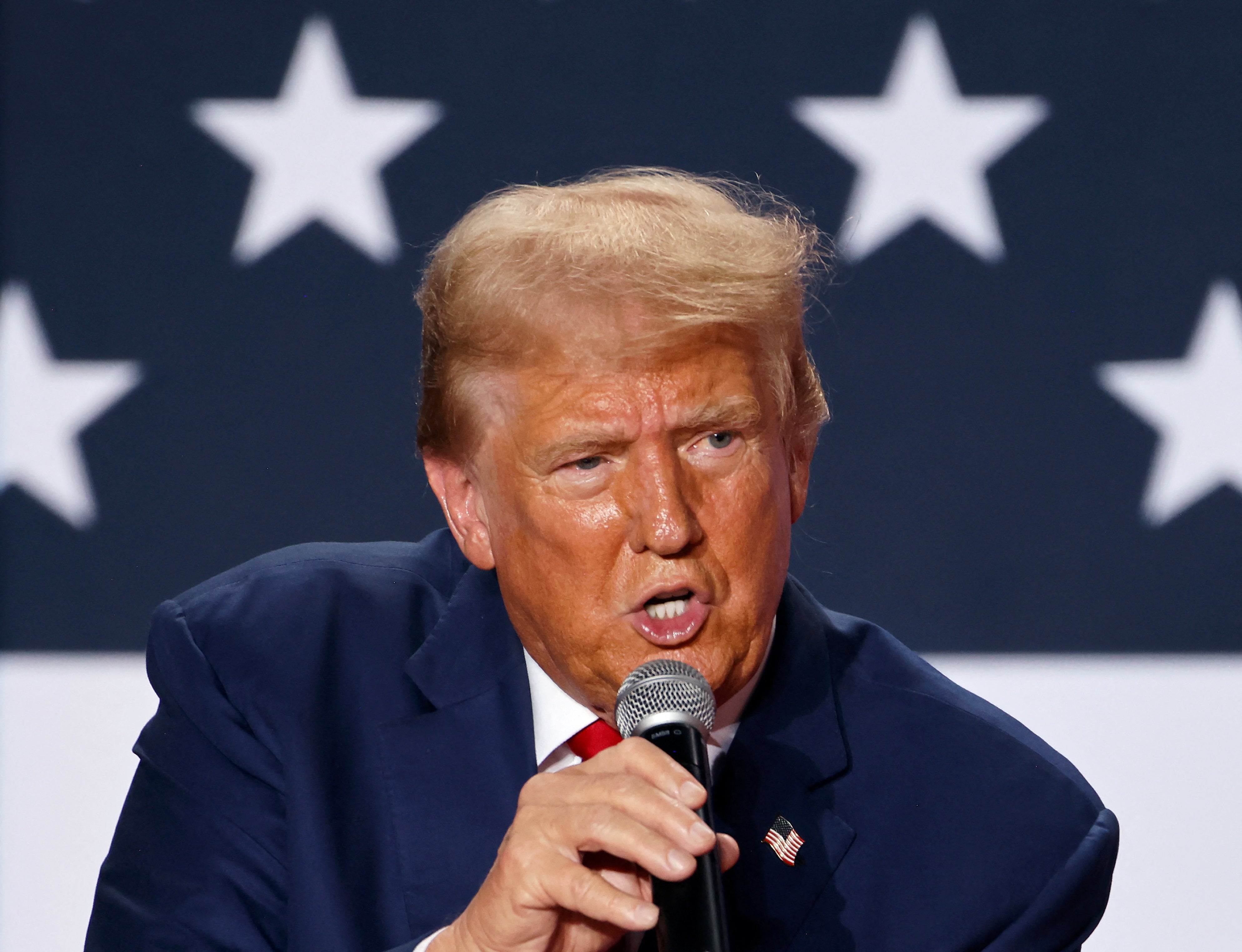 Republican presidential nominee and former U.S. President Donald Trump speaks at a town hall as he campaigns in Fayetteville, North Carolina. The former president plans to return to Butler, Pennsylvania, the site of the assassination attempt in July