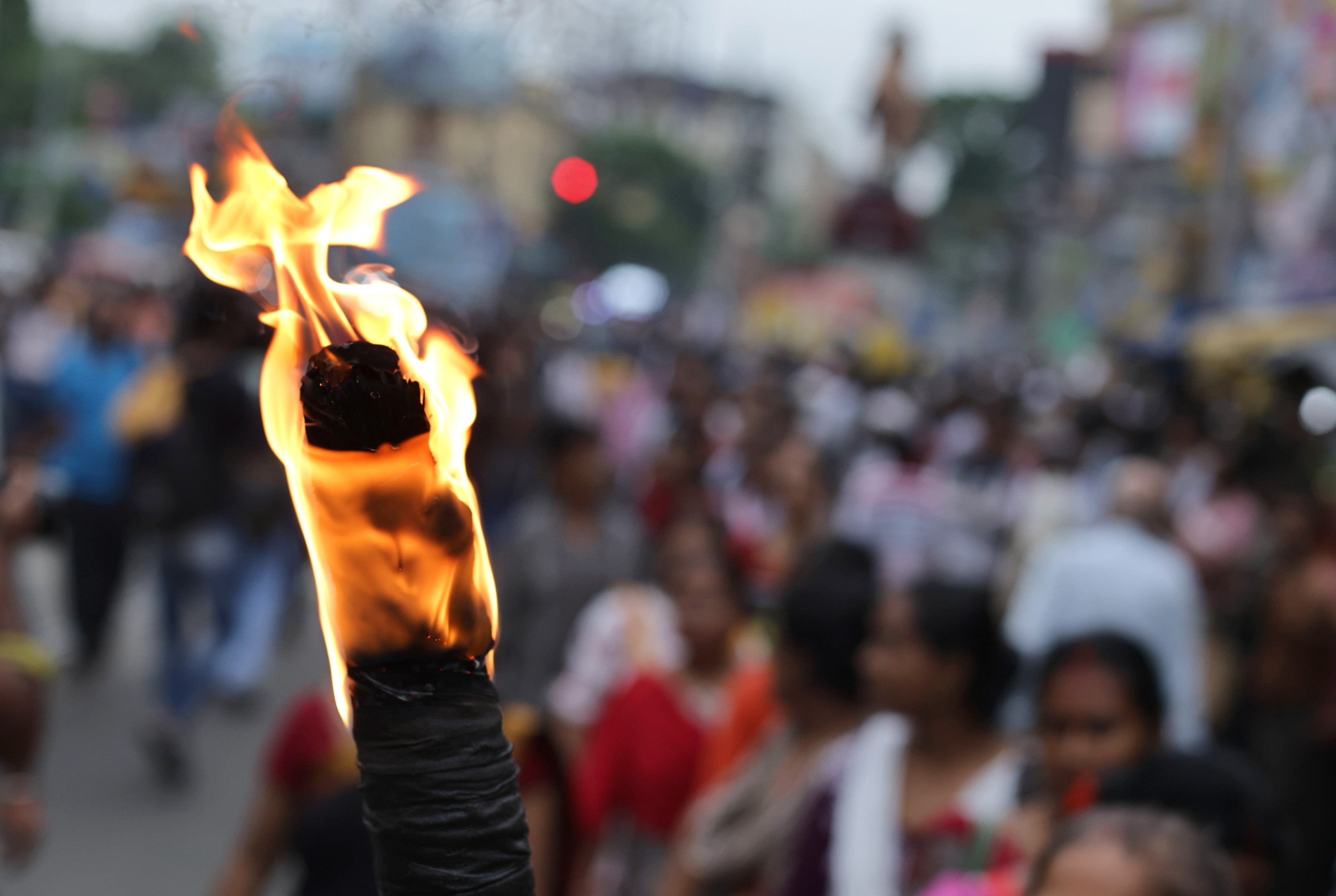 A protester holds torch as people march during a rally against rape and murder at RG Kar medical college