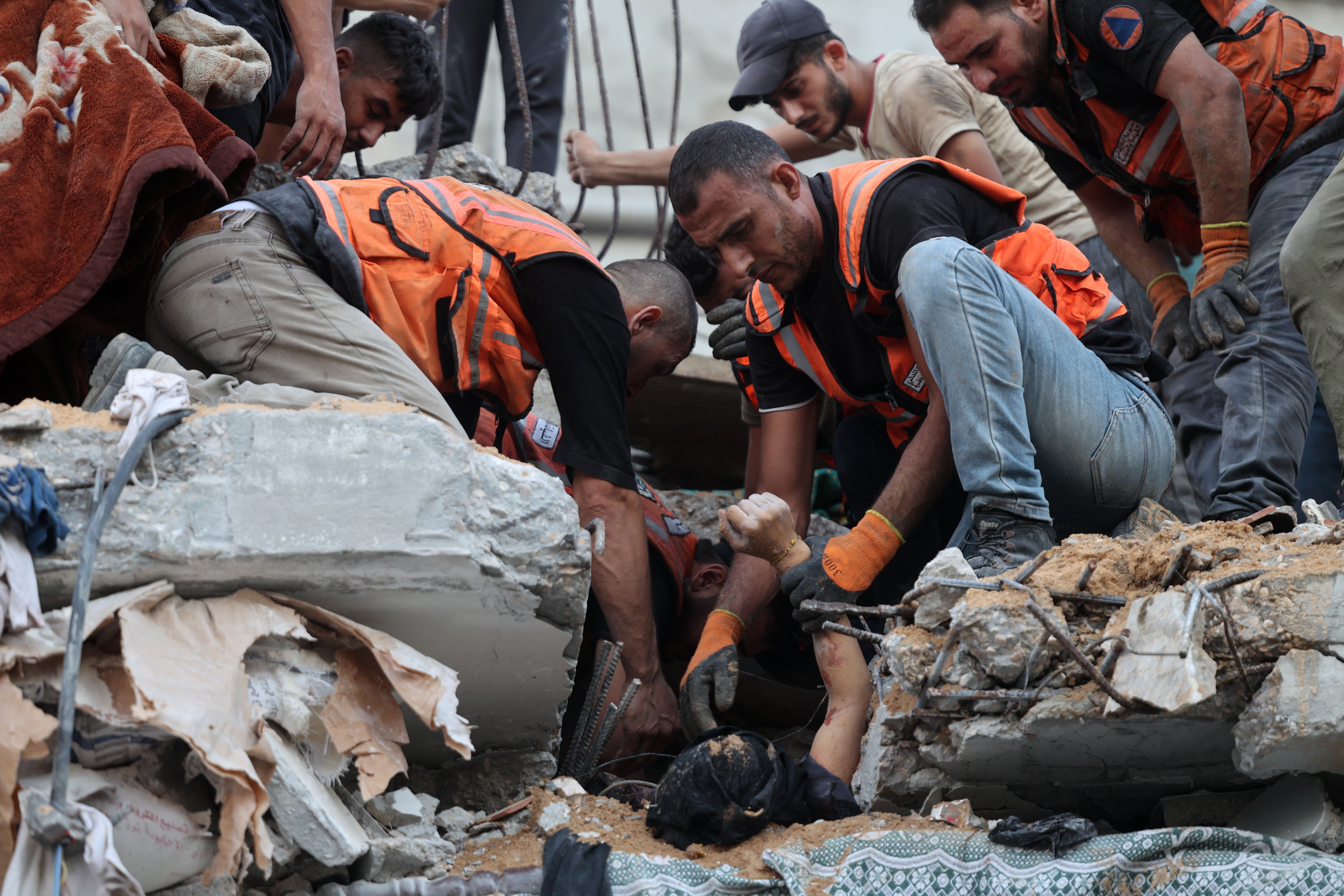 Palestinian medics unearth a body after an Israeli strike on a building in the al-Daraj neighbourhood in Gaza City in September