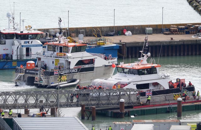 <p>Groups of people thought to be migrants are brought in to Dover, Kent, on Friday onboard Border Force vessels</p>