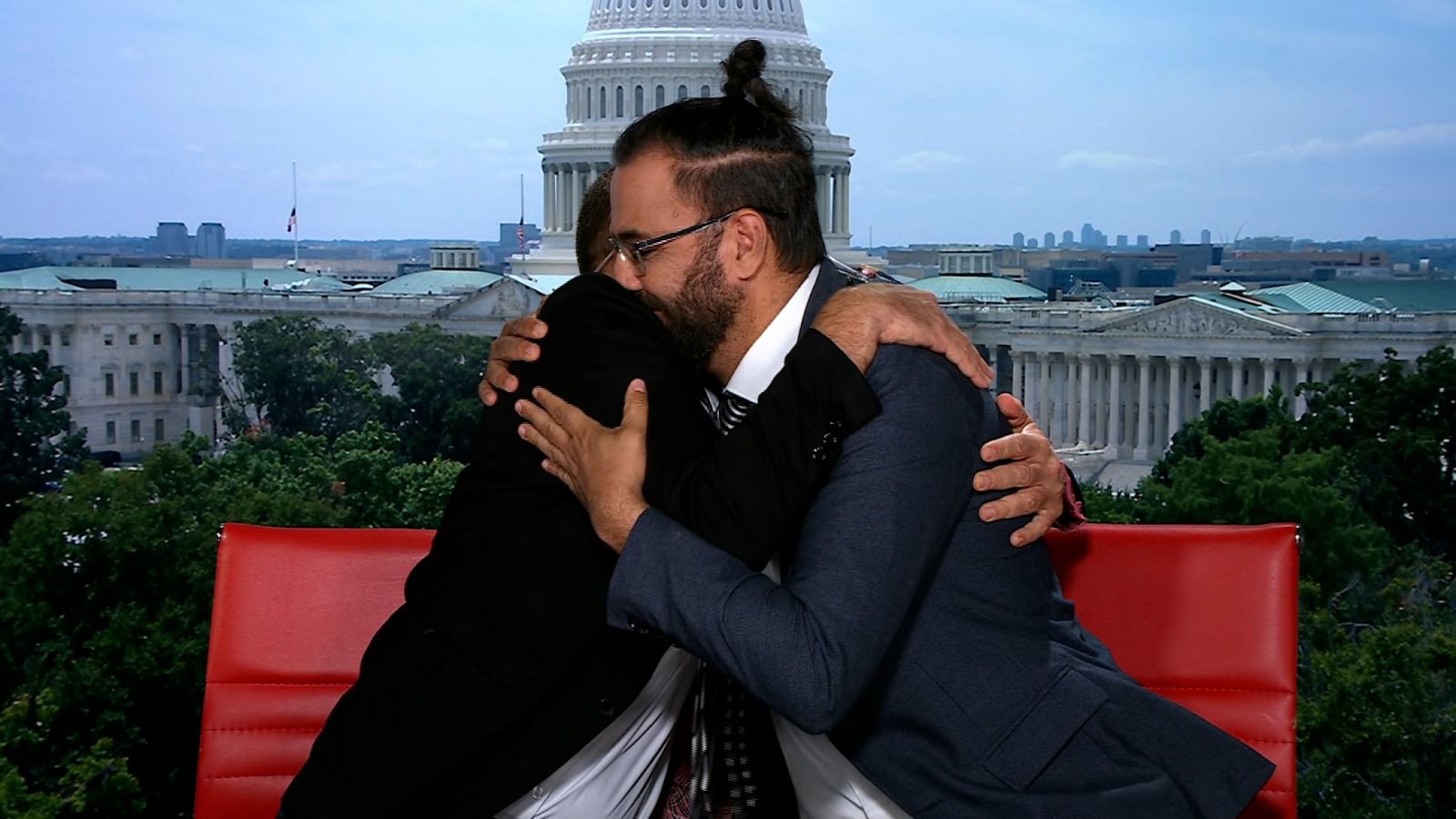 Maoz Inon and Aziz Abu Sarah embrace after speaking about their message of peace on Christiane Amanpour’s show