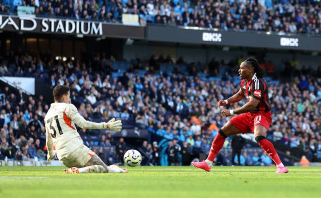 <p>Ederson saves at the feet of Fulham winger Adama Traore</p>