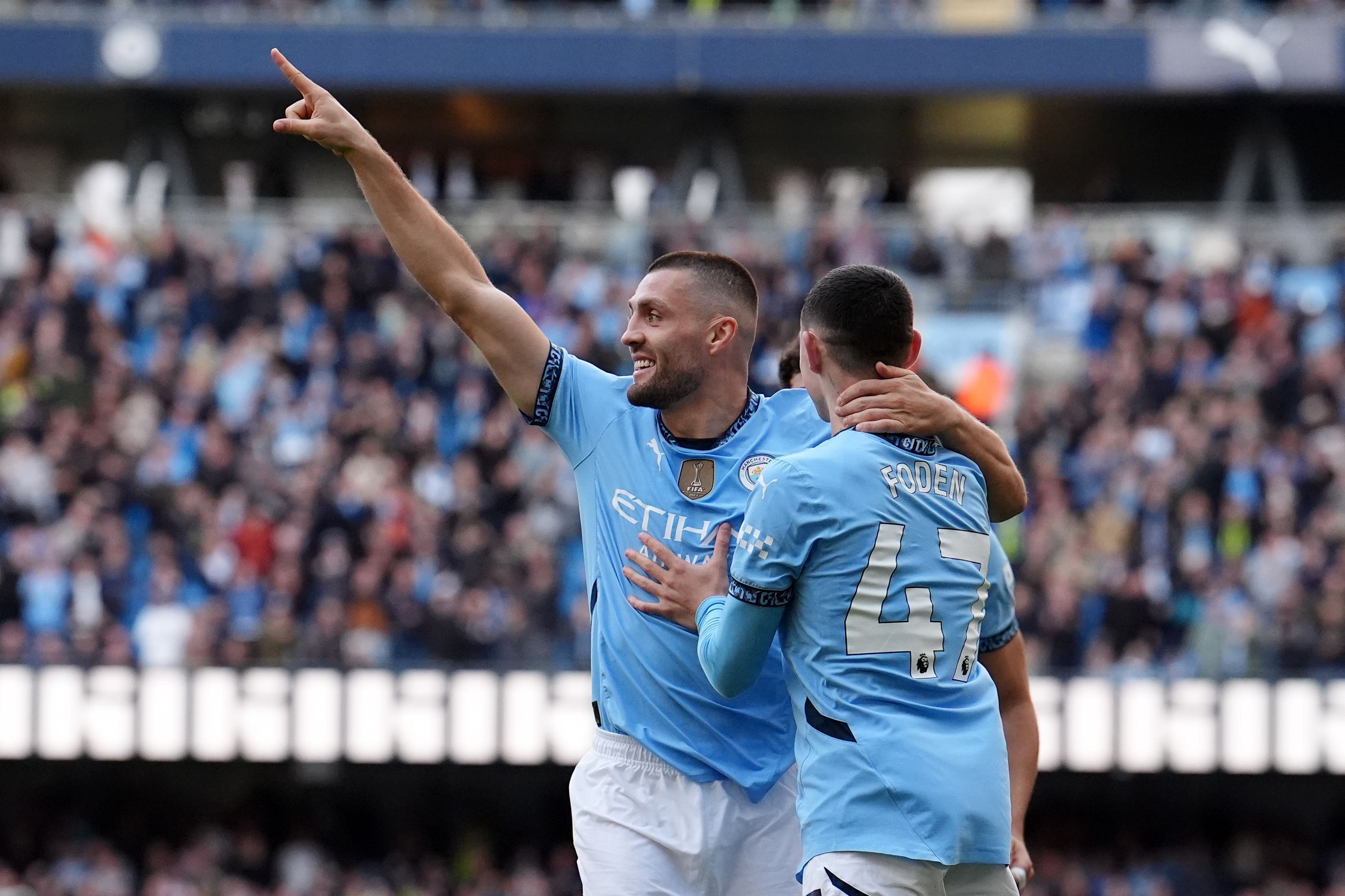 Mateo Kovacic (left) celebrates with Phil Foden after scoring Manchester City’s second (Martin Rickett/PA)